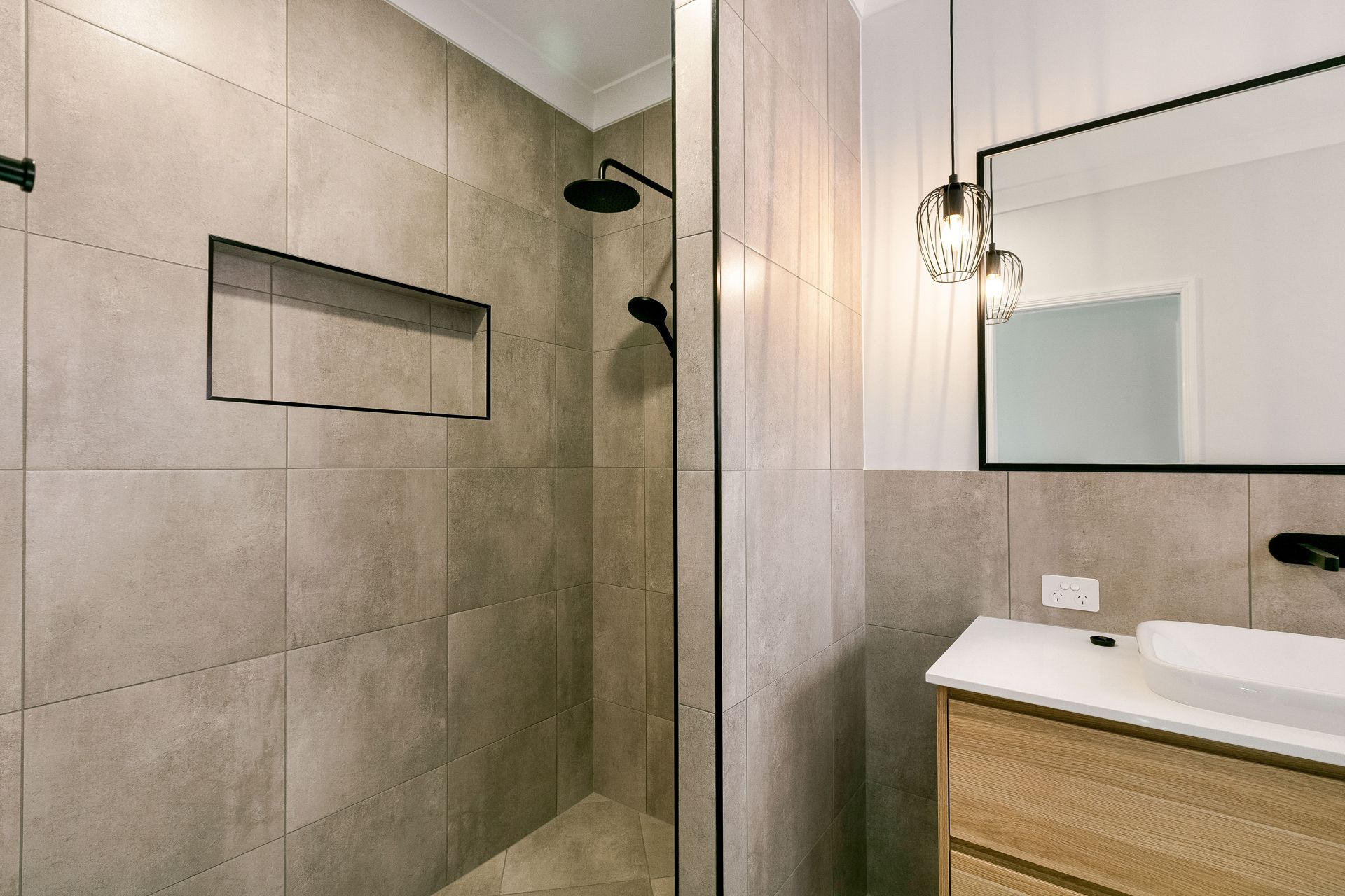 Modern Bathroom With Beige Tiled Shower, a Built-in Wall Niche — Ashlee Jones Homes in Gordonvale, QLD