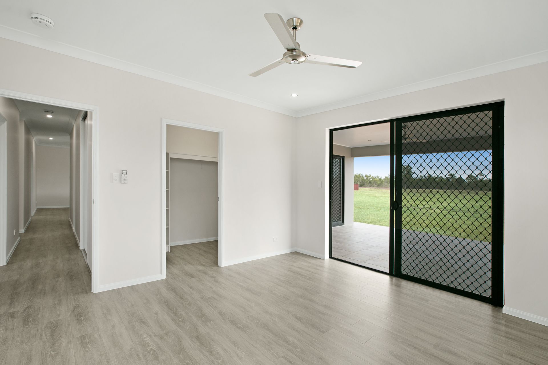 A Minimalist Room With Light Wood-look Flooring — Ashlee Jones Homes in Gordonvale, QLD