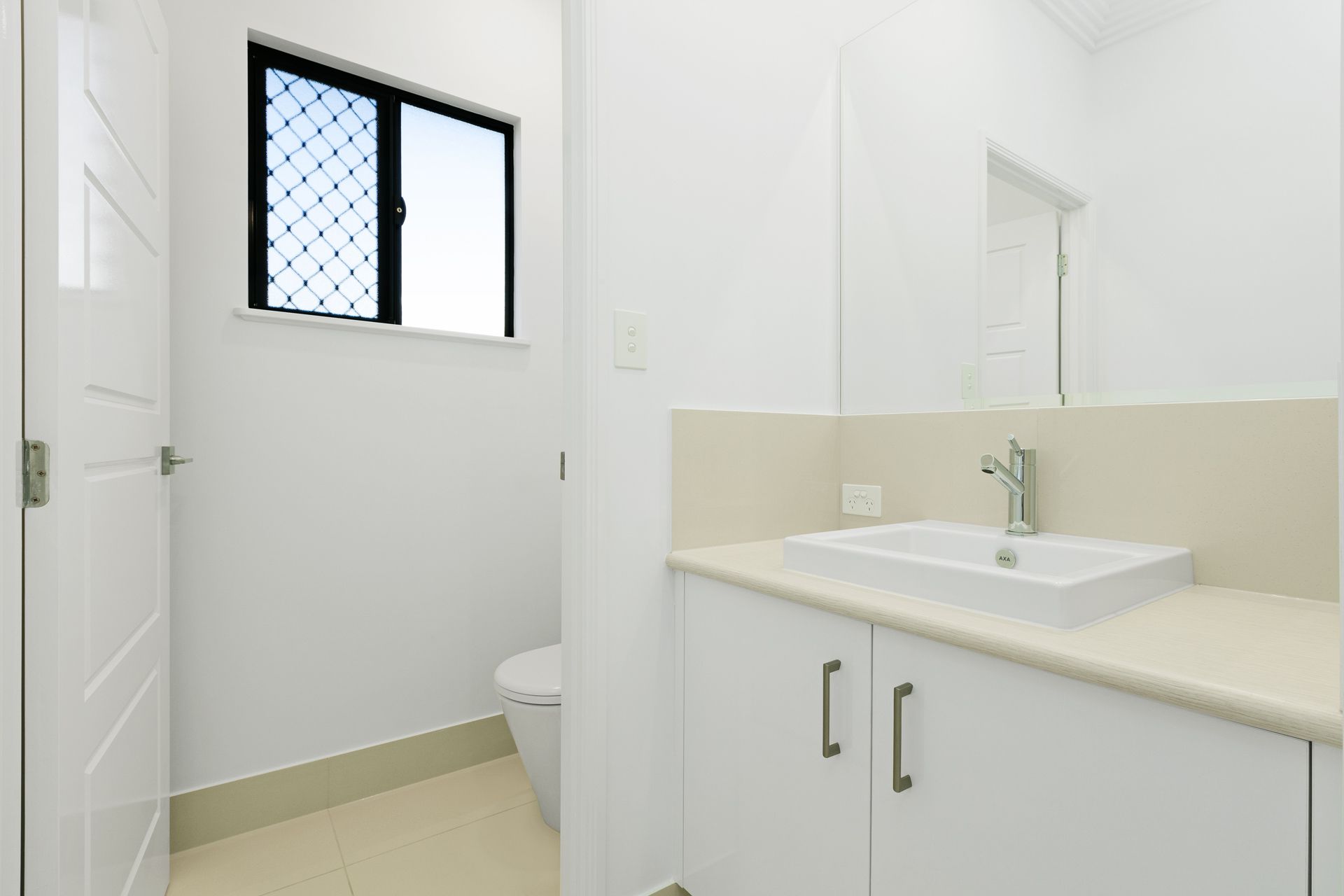 A Bright Modern Bathroom Featuring a White Vanity With a Square Sink — Ashlee Jones Homes in Gordonvale, QLD