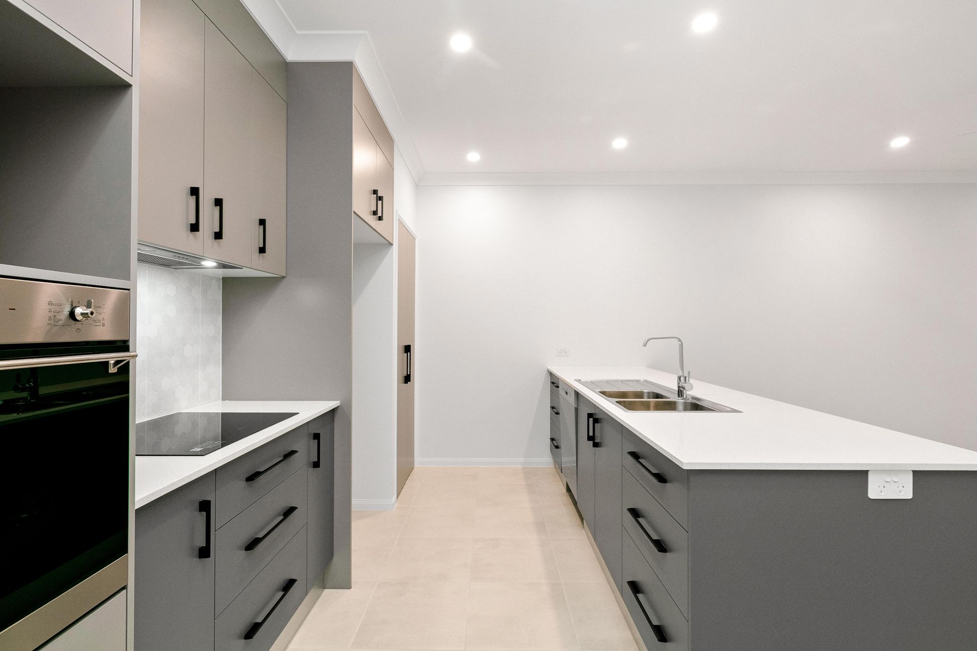 A Modern Kitchen Featuring Grey Cabinets — Ashlee Jones Homes in Gordonvale, QLD
