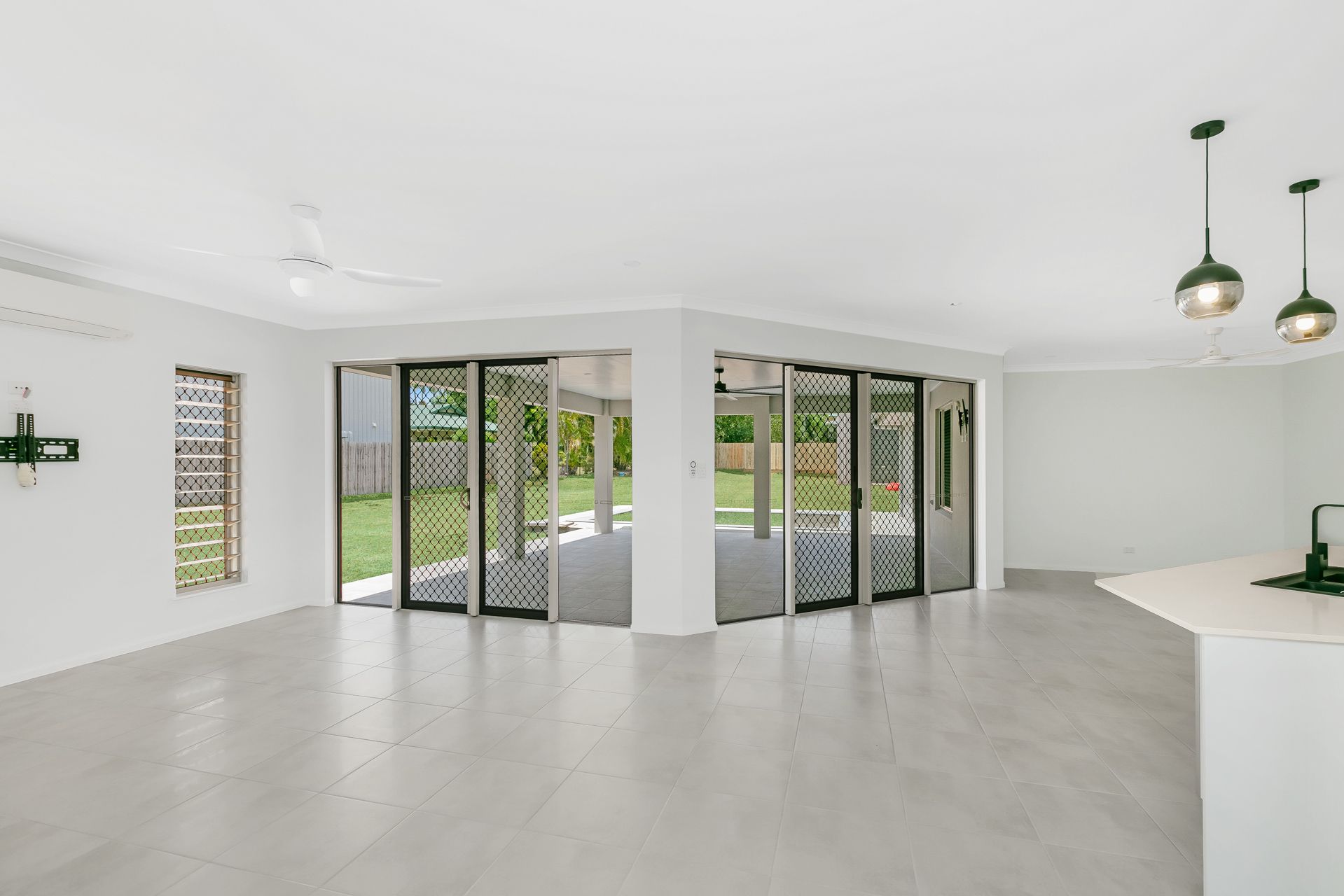 A Bright, Open-plan Living Room With White Walls — Ashlee Jones Homes in Gordonvale, QLD