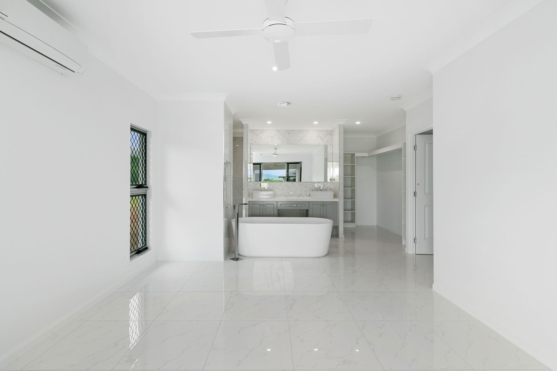 A Bright, Modern Bathroom With a Freestanding White Tub — Ashlee Jones Homes in Gordonvale, QLD
