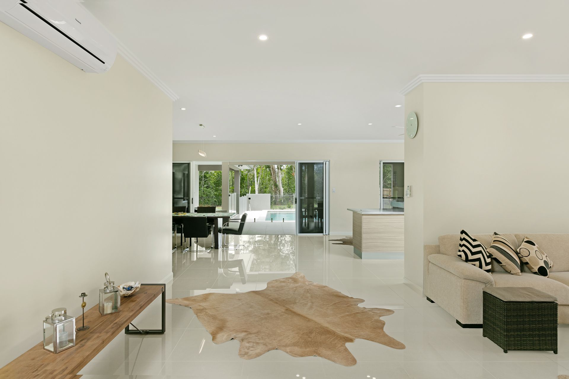 A Modern, Airy Living Room With a Beige Sofa, Animal-print Rug — Ashlee Jones Homes in Gordonvale, QLD