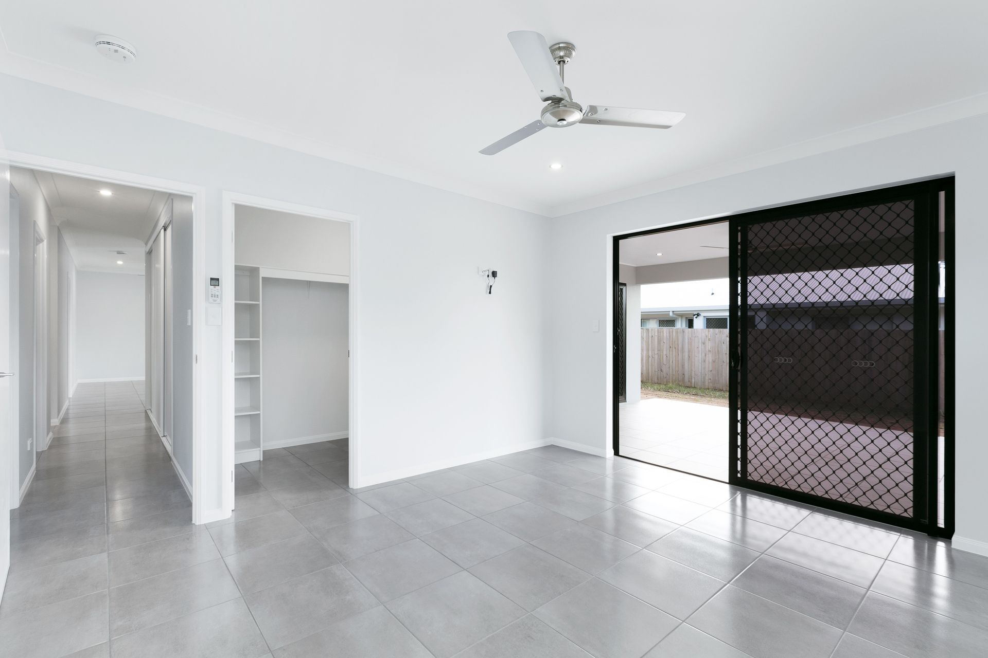 An Empty Room With White Walls, Gray Tile Floors — Ashlee Jones Homes in Gordonvale, QLD