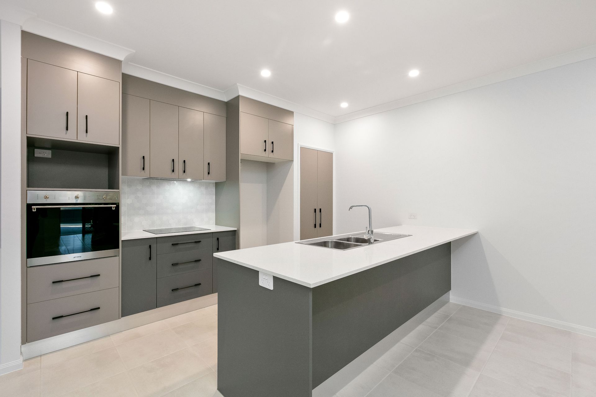 Modern Kitchen With Gray Cabinets, White Stone Countertops — Ashlee Jones Homes in Gordonvale, QLD