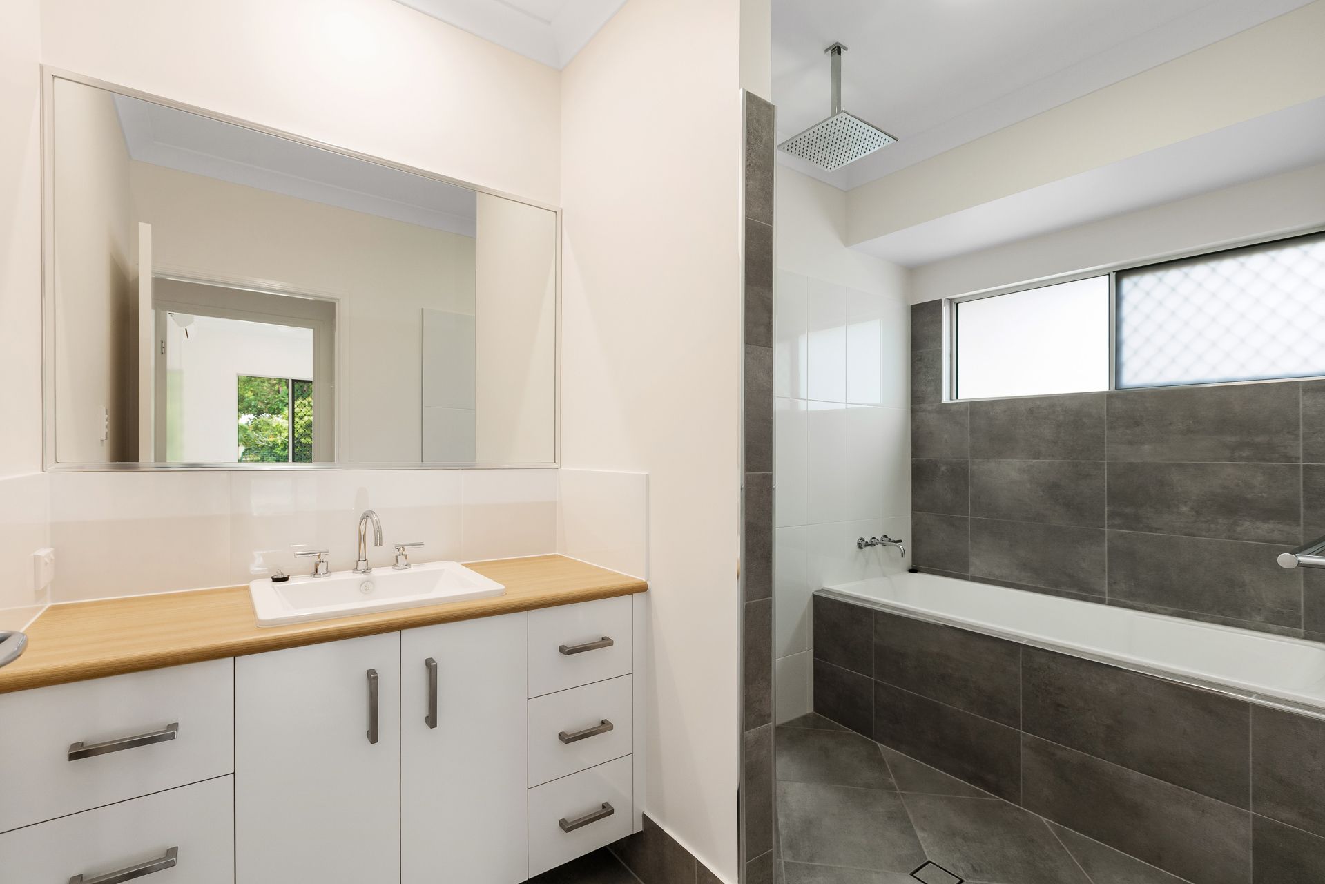 A Clean, Modern Bathroom With a White Vanity — Ashlee Jones Homes in Gordonvale, QLD