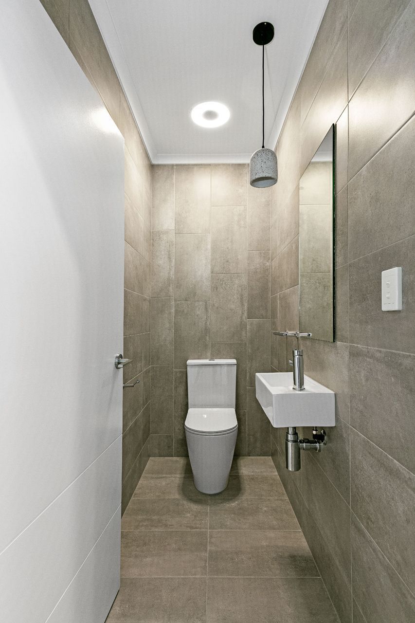 A Modern, Minimalist Bathroom With Gray Stone Tiles — Ashlee Jones Homes in Gordonvale, QLD