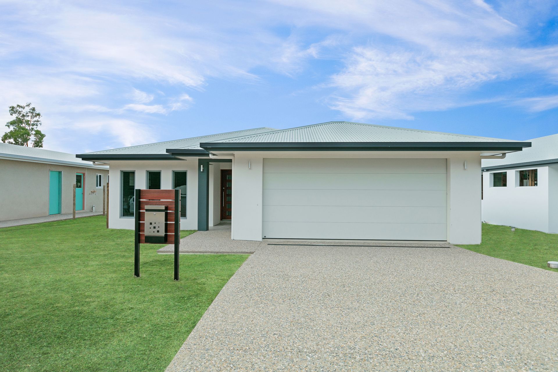 A Modern Single-story House With a White Exterior — Ashlee Jones Homes in Gordonvale, QLD