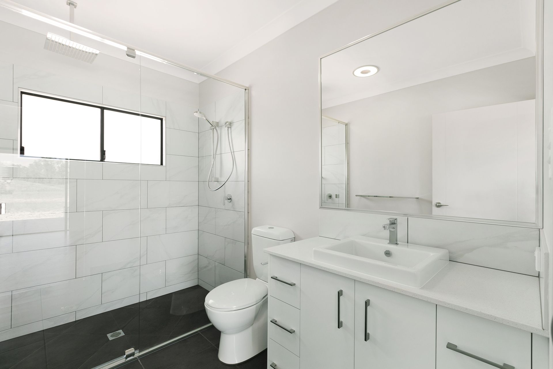 Modern Bathroom Featuring a White Vanity — Ashlee Jones Homes in Gordonvale, QLD