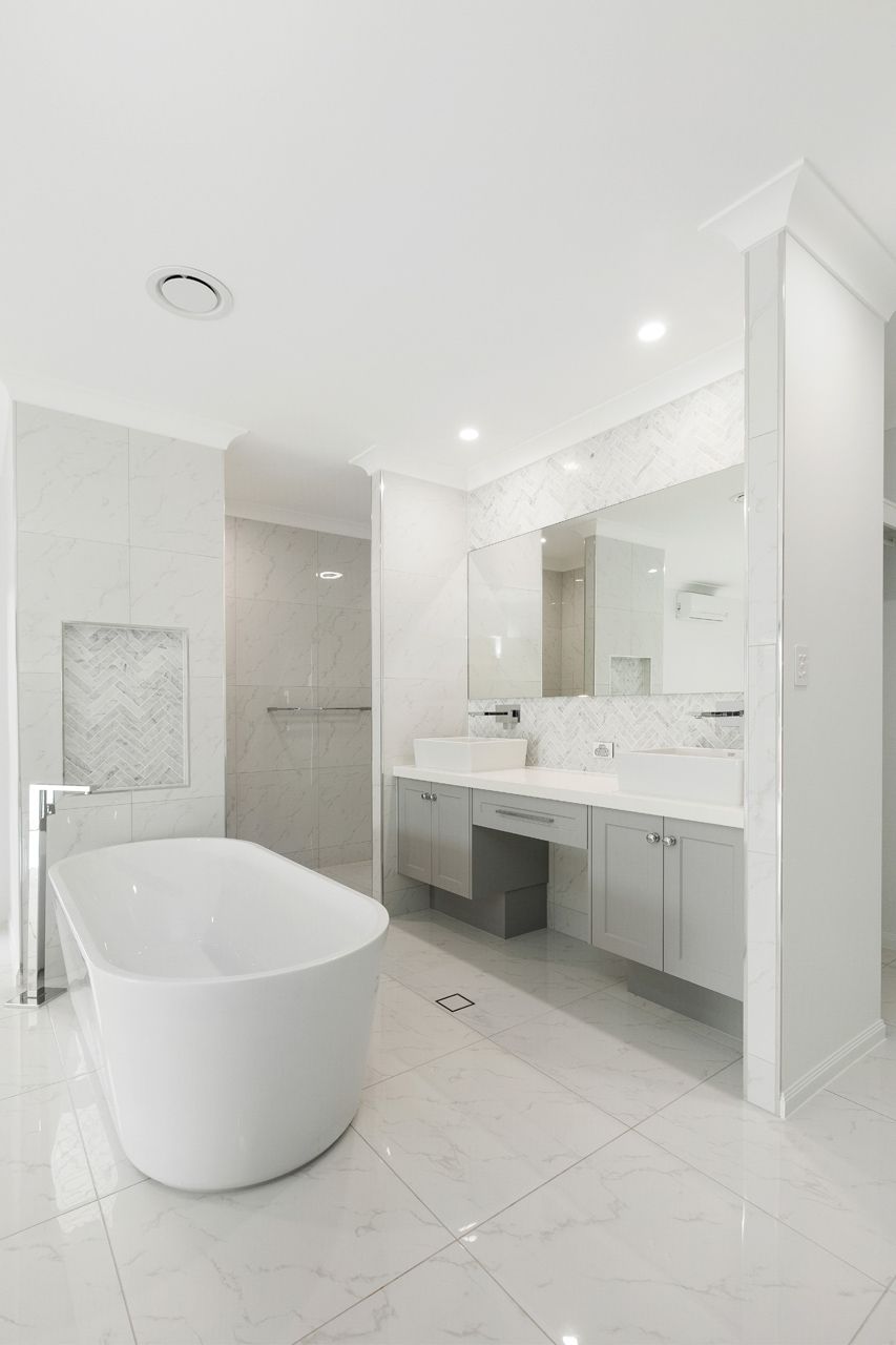 A Modern, Bright Bathroom With a Freestanding White Bathtub — Ashlee Jones Homes in Gordonvale, QLD