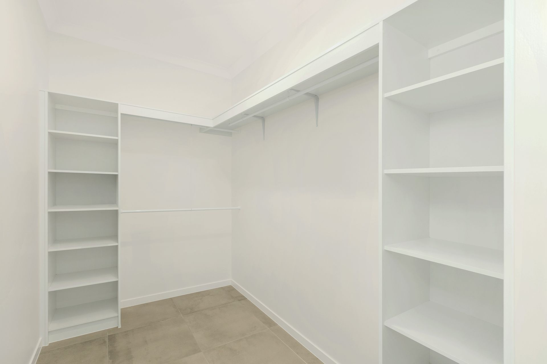 Empty Walk-in Closet Featuring White Shelving Units — Ashlee Jones Homes in Gordonvale, QLD