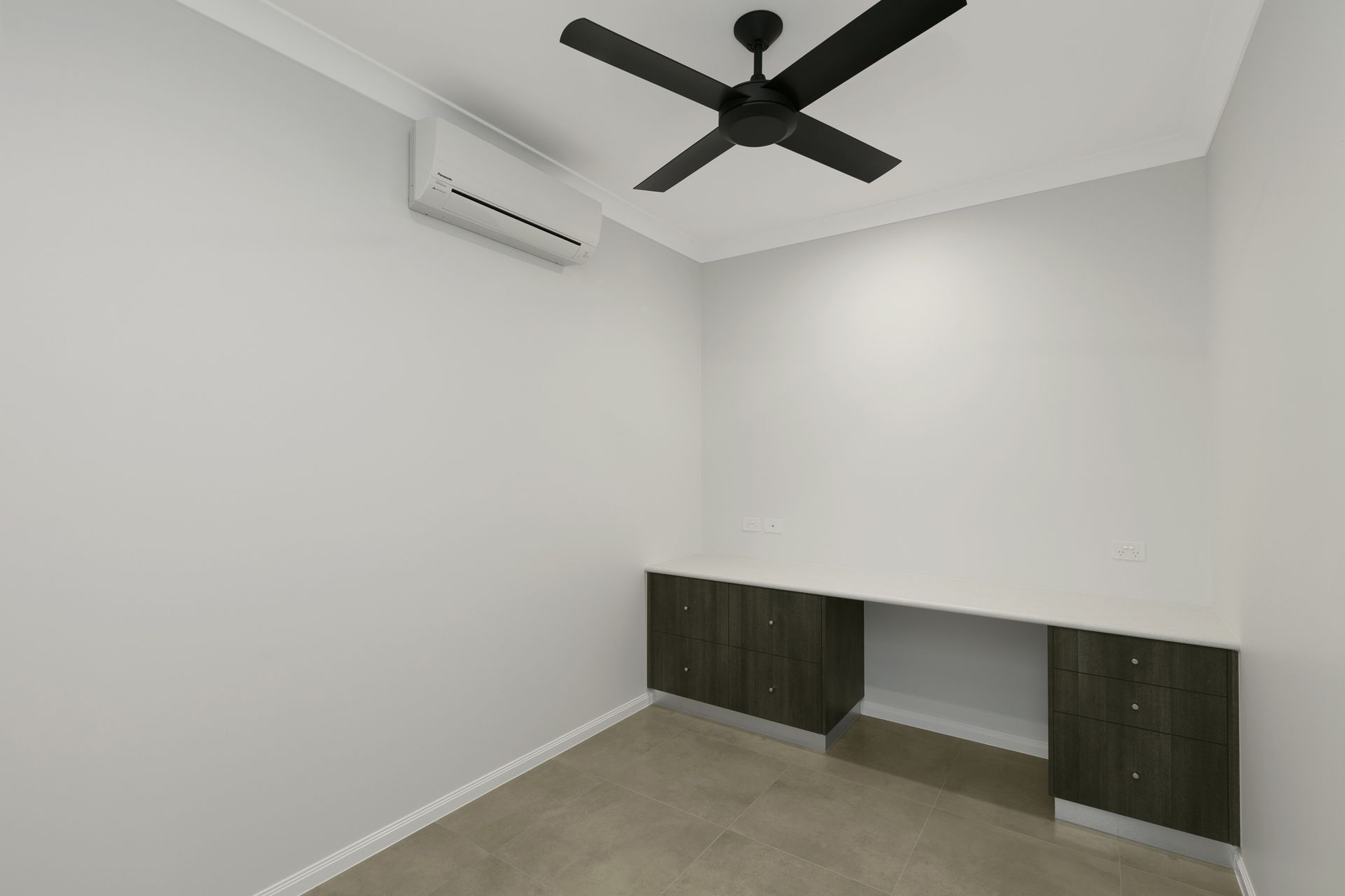 A Small, Empty Room With Grey Walls, Concrete Flooring — Ashlee Jones Homes in Gordonvale, QLD