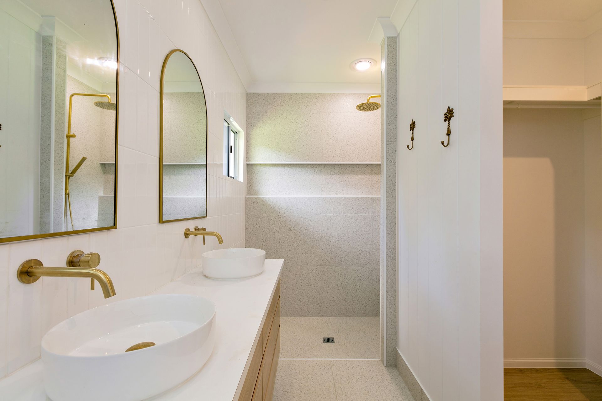 A Modern Bathroom With a Double White Vessel Sink Vanity — Ashlee Jones Homes in Gordonvale, QLD