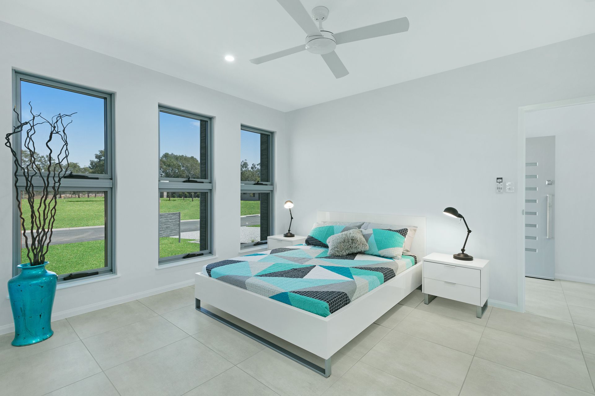 Modern, Bright Bedroom With White Walls, Tiled Floor — Ashlee Jones Homes in Gordonvale, QLD