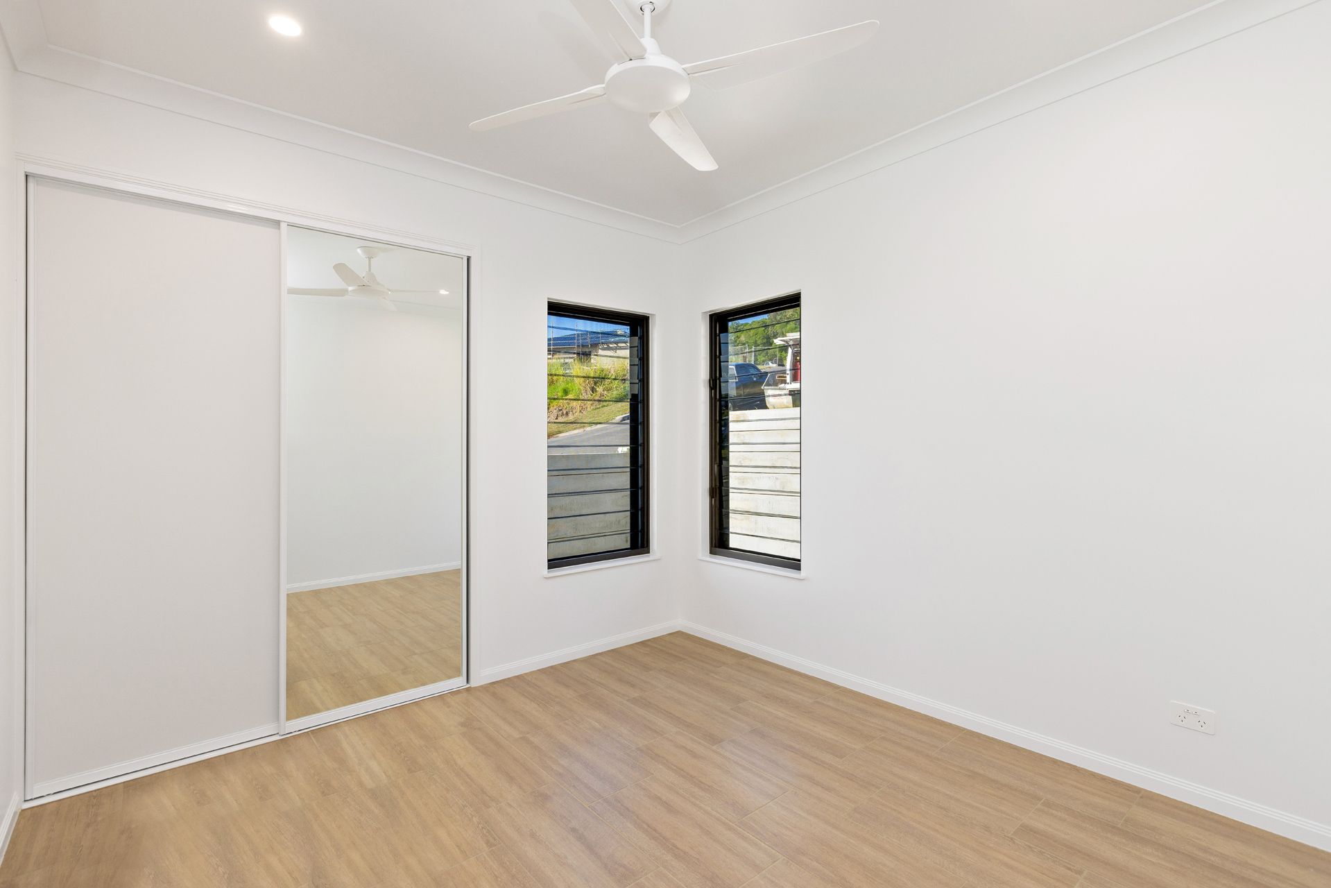 A Bright, Empty Bedroom With White Walls — Ashlee Jones Homes in Gordonvale, QLD