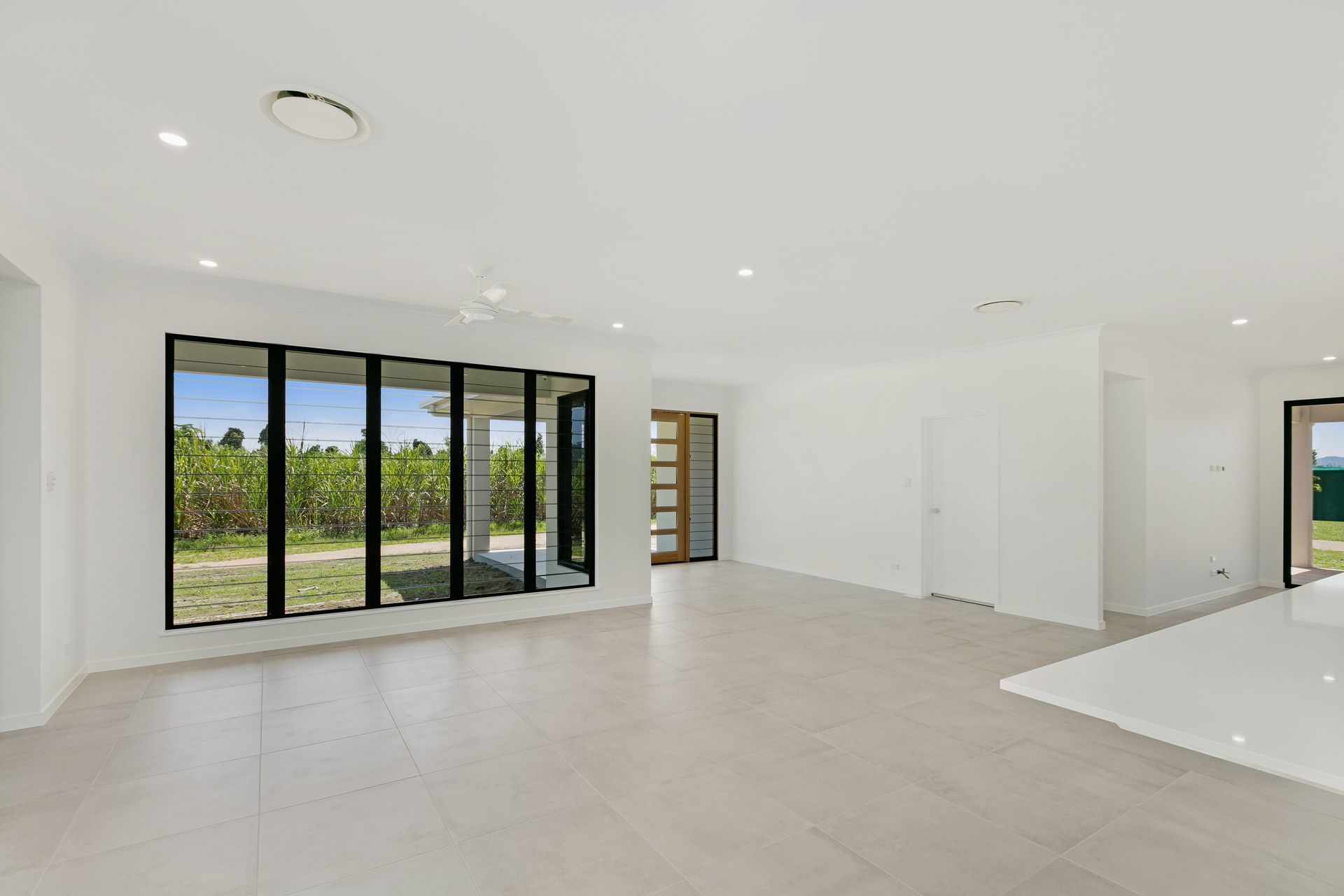 A Spacious, Minimalist Living Room With White Walls — Ashlee Jones Homes in Gordonvale, QLD