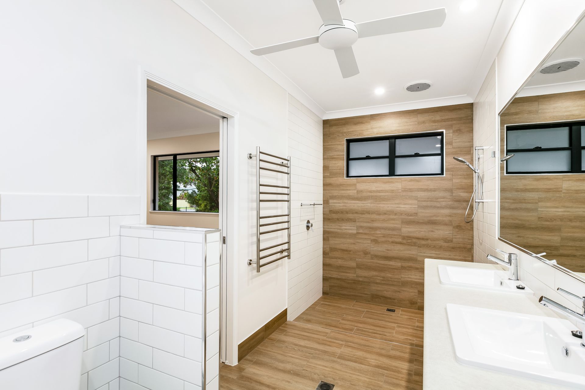 A Modern Bathroom With White Subway Tile — Ashlee Jones Homes in Gordonvale, QLD