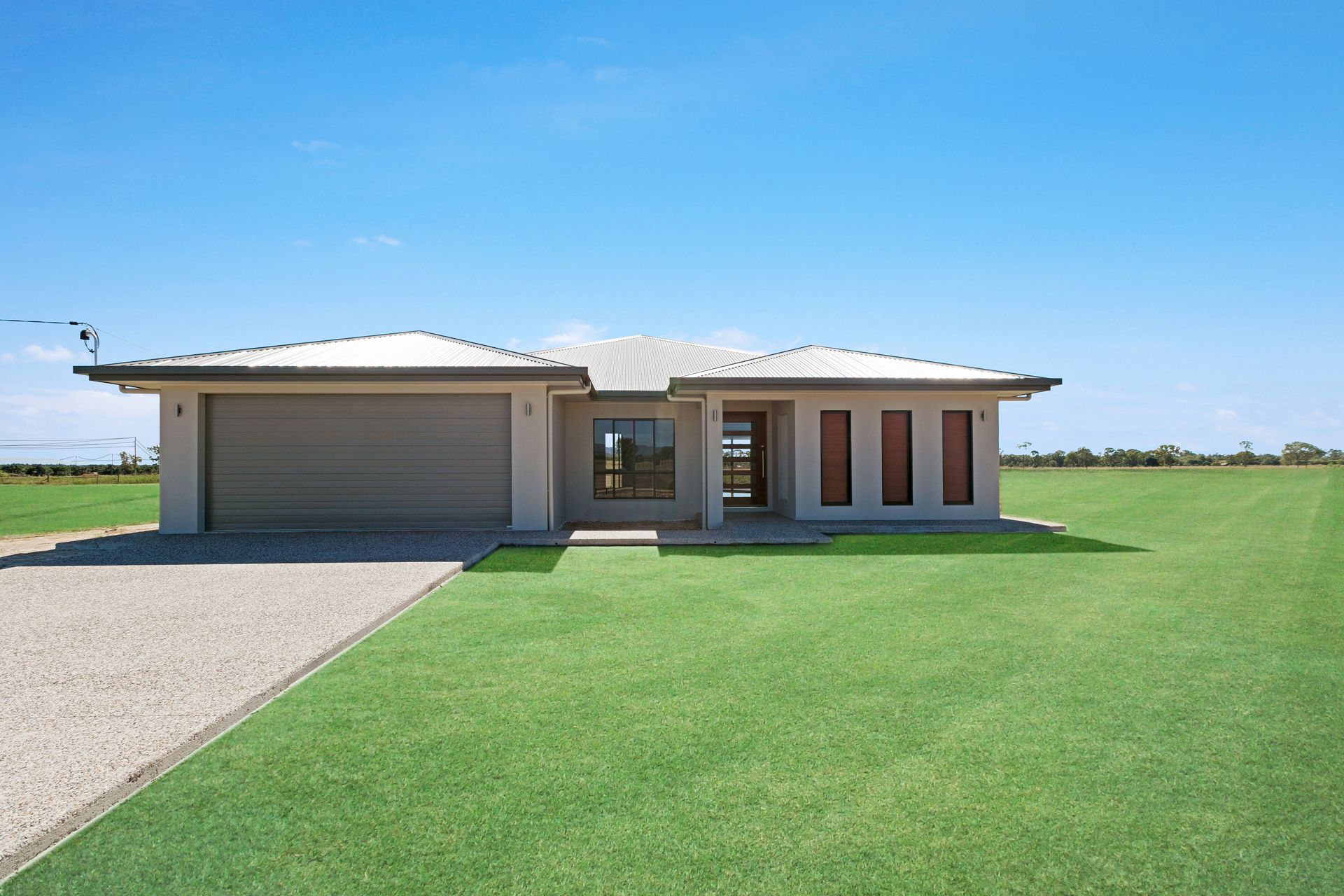 A Beige Single-story House With a Tan Garage — Ashlee Jones Homes in Gordonvale, QLD
