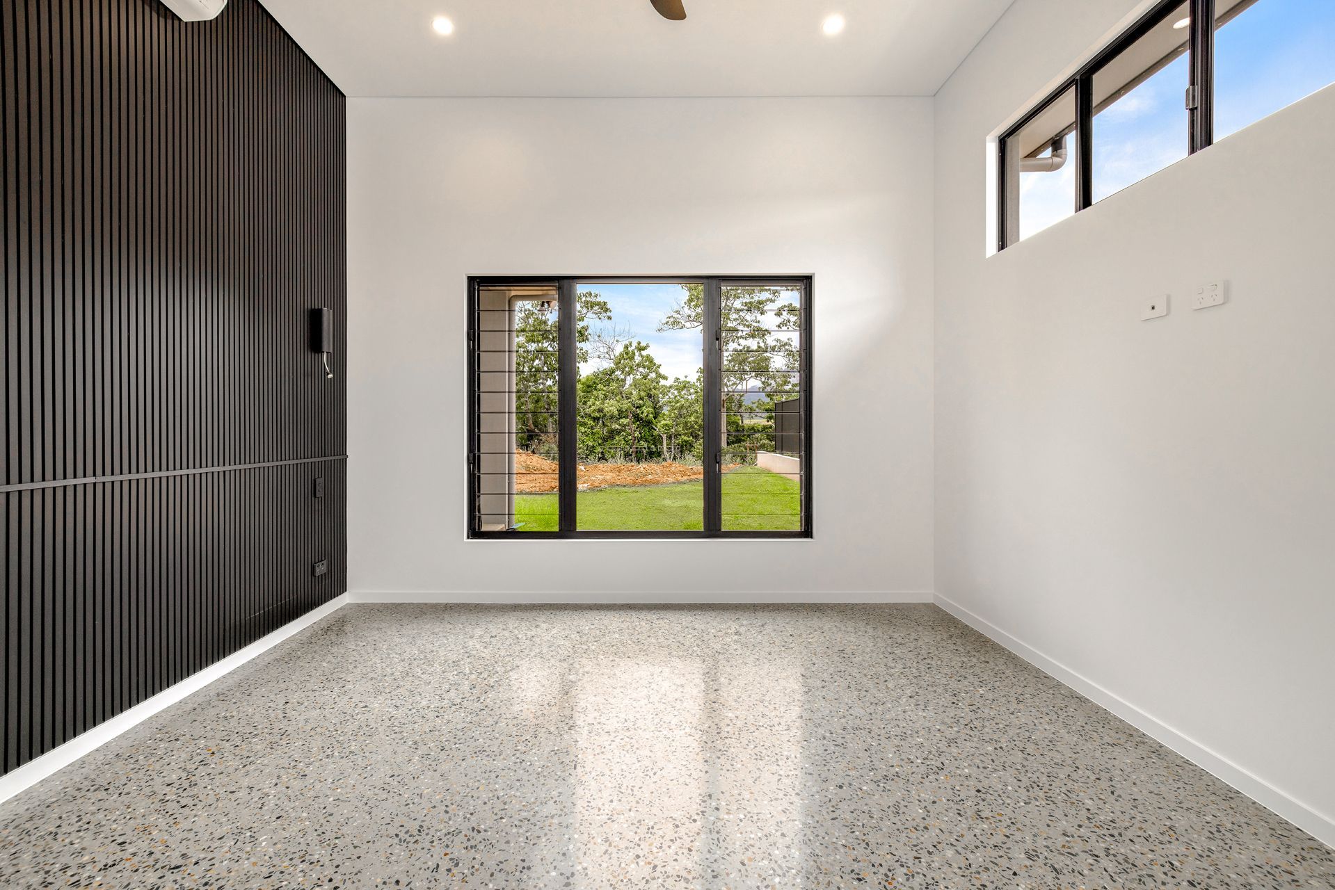 An Empty, Modern Room With Light Walls, Terrazzo Flooring — Ashlee Jones Homes in Gordonvale, QLD