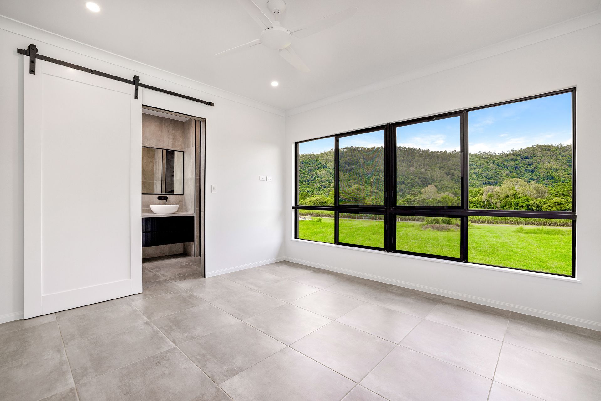 Modern Bedroom With Light Grey Tile Floors — Ashlee Jones Homes in Gordonvale, QLD