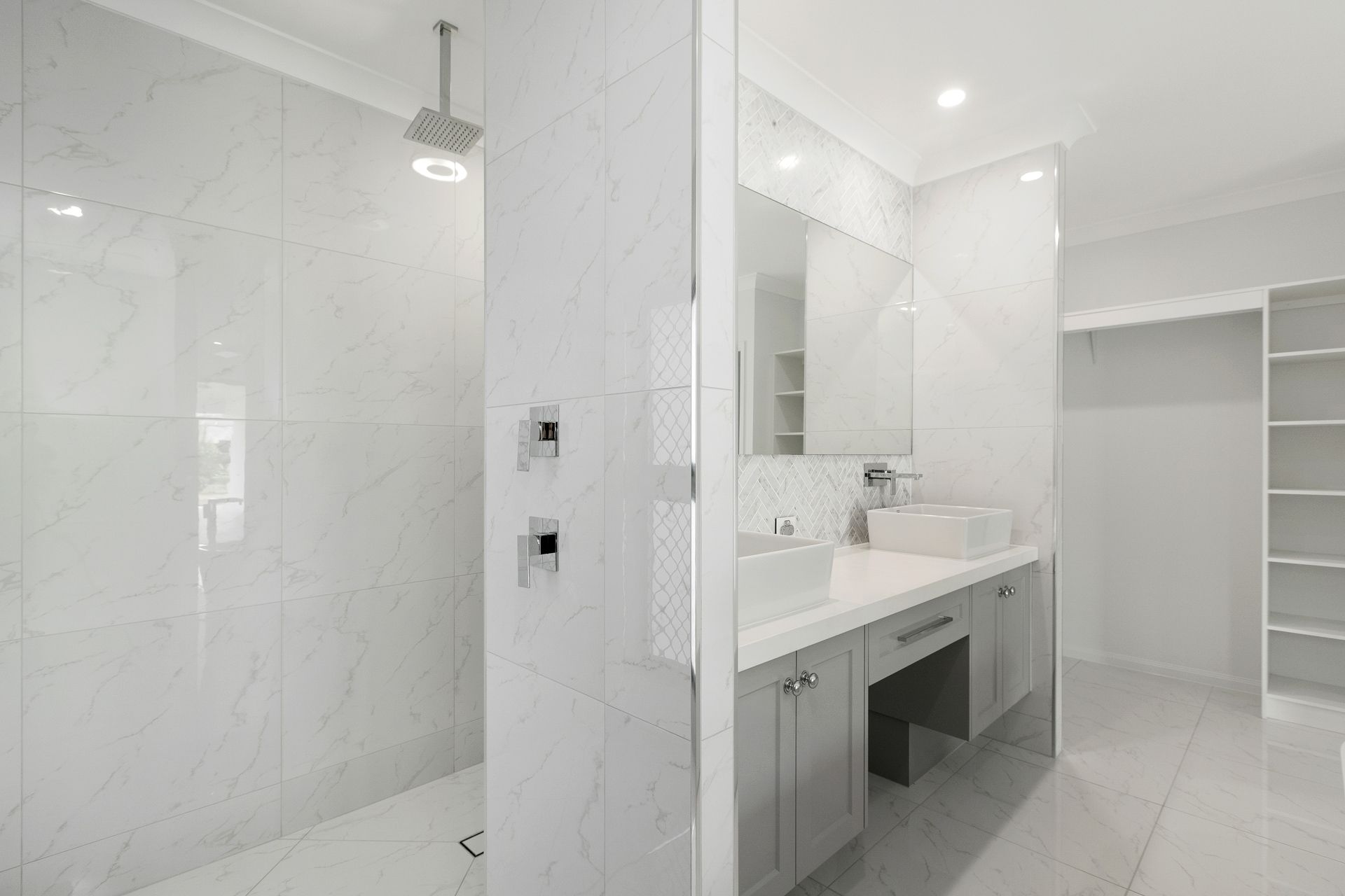 A Modern, Bright Bathroom With Marble-tiled Walls — Ashlee Jones Homes in Gordonvale, QLD