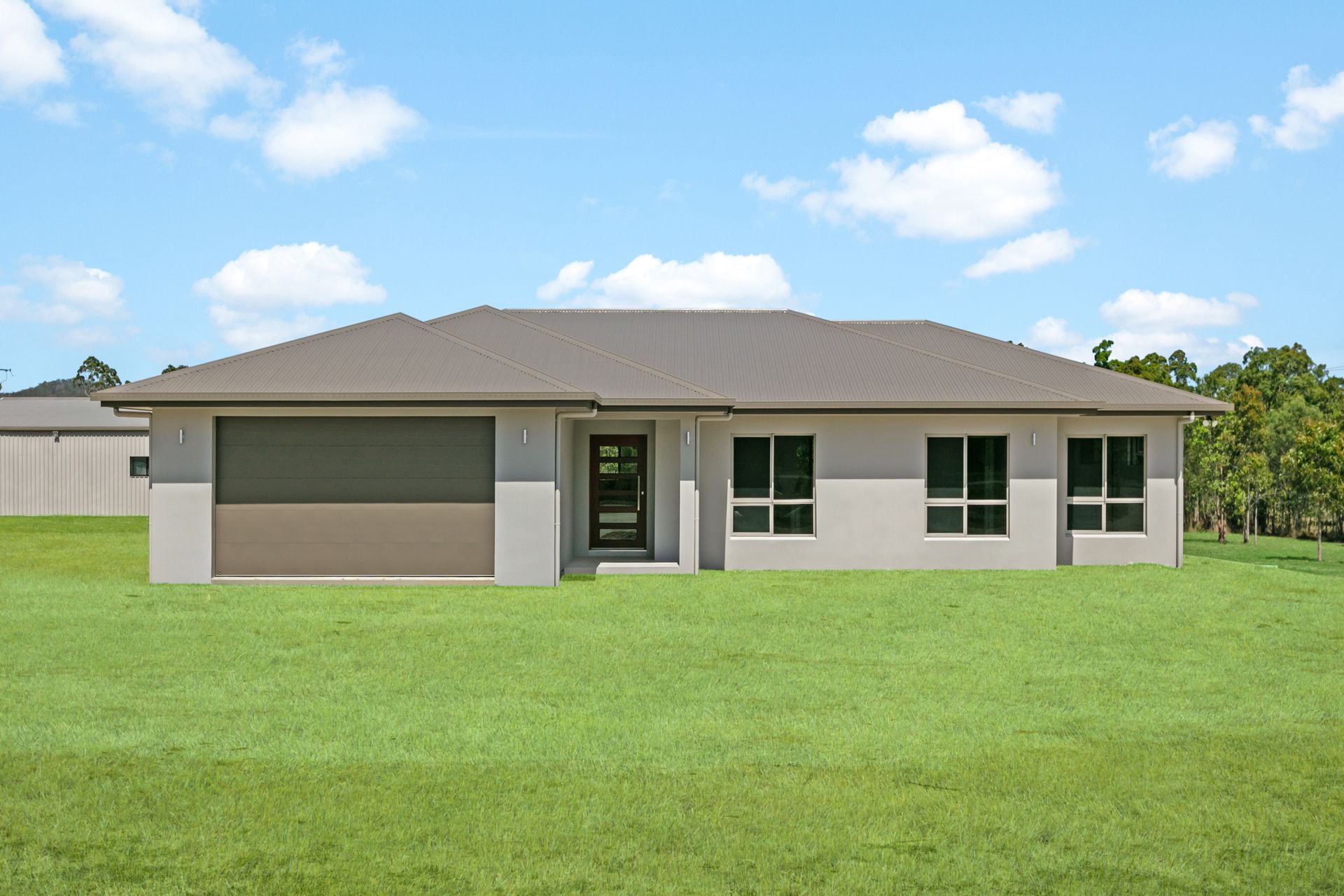 A Single-story, Beige Suburban House With a Brown Garage Door and Roof — Ashlee Jones Homes in Gordonvale, QLD