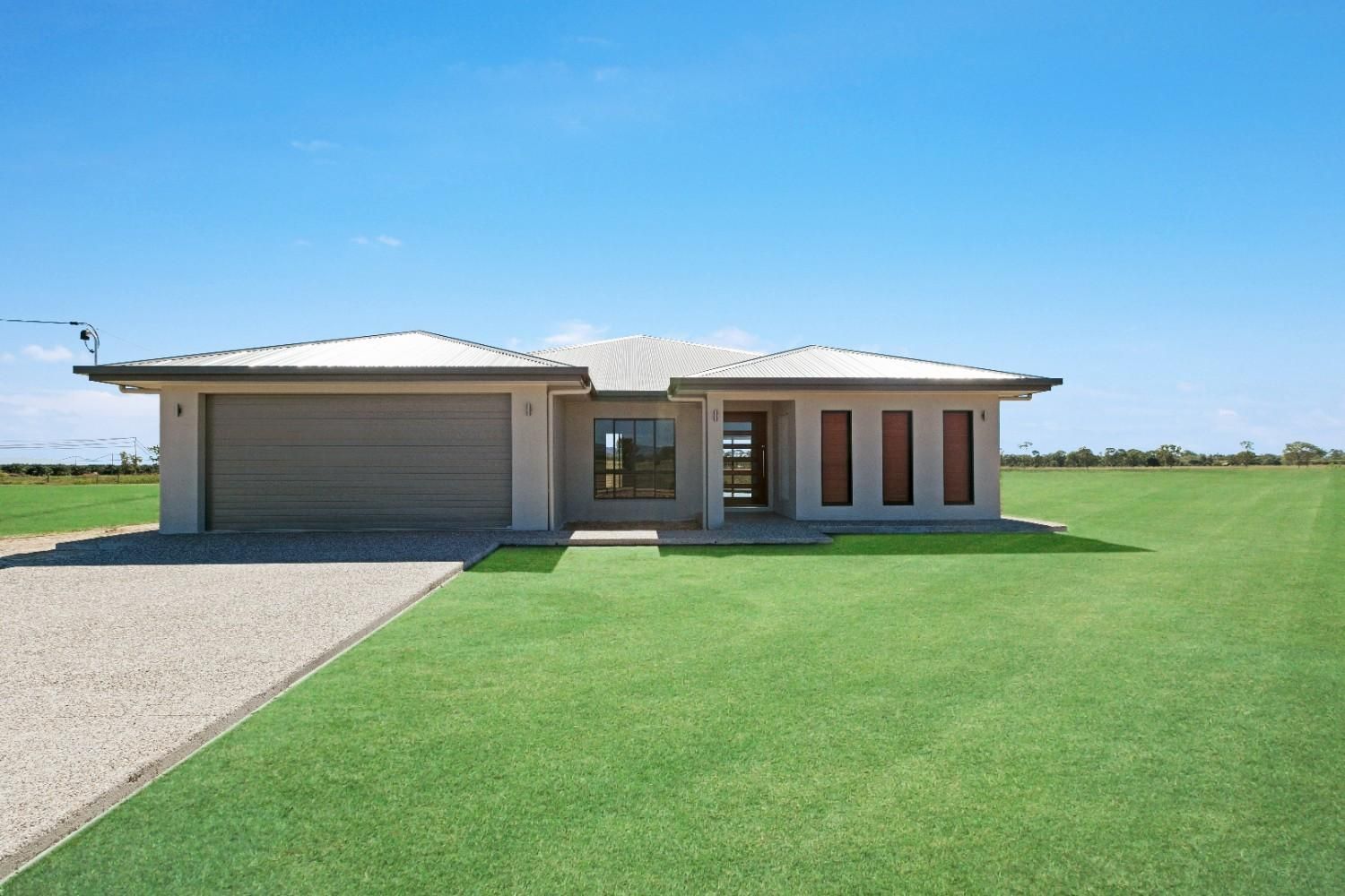 A White House With a Blue Roof and a Wooden Door — Ashlee Jones Homes in Gordonvale, QLD