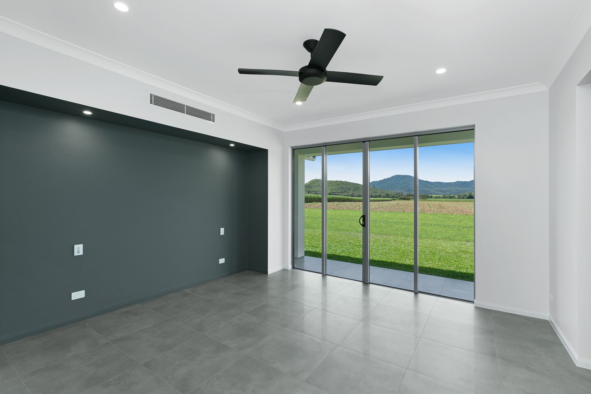 A Modern, Minimalist Room With a Dark Gray Feature Wall — Ashlee Jones Homes in Gordonvale, QLD