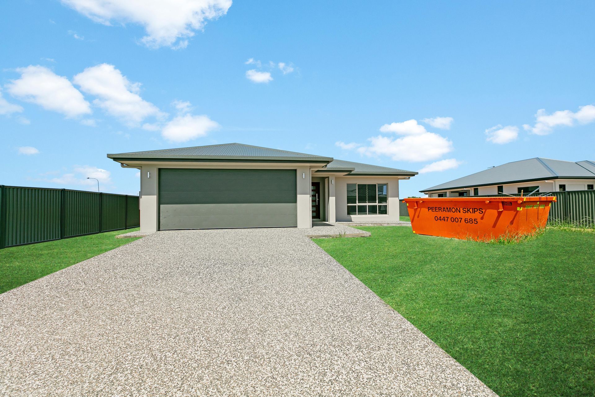 Single-story Suburban House With a Gray Garage, Pebble Driveway — Ashlee Jones Homes in Gordonvale, QLD