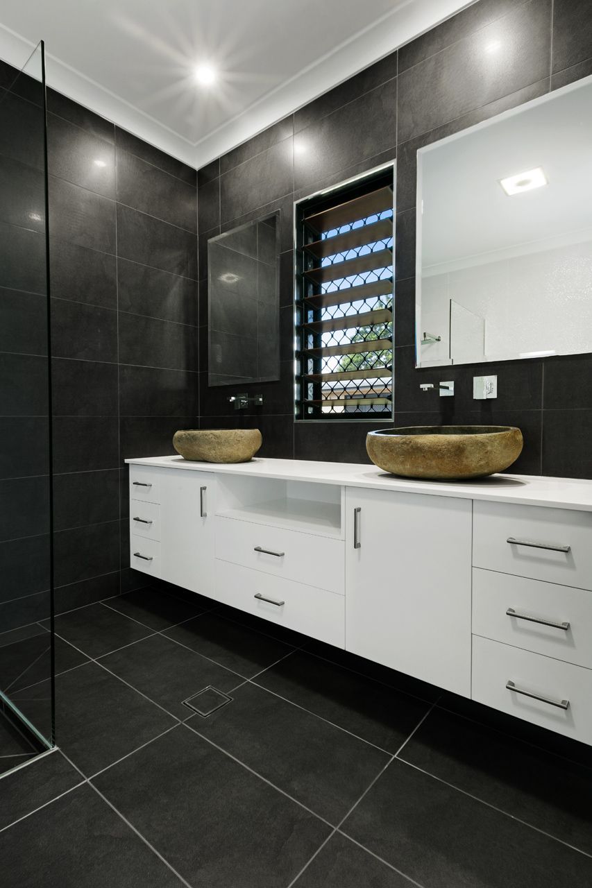 Modern Bathroom With Black Tiled Walls and Floors — Ashlee Jones Homes in Gordonvale, QLD