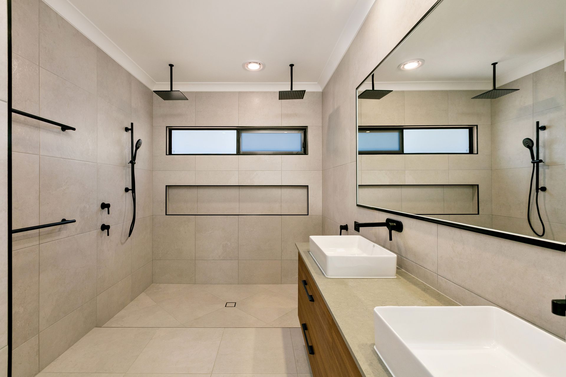 A Modern, Light-toned Bathroom Featuring a Walk-in Shower — Ashlee Jones Homes in Gordonvale, QLD