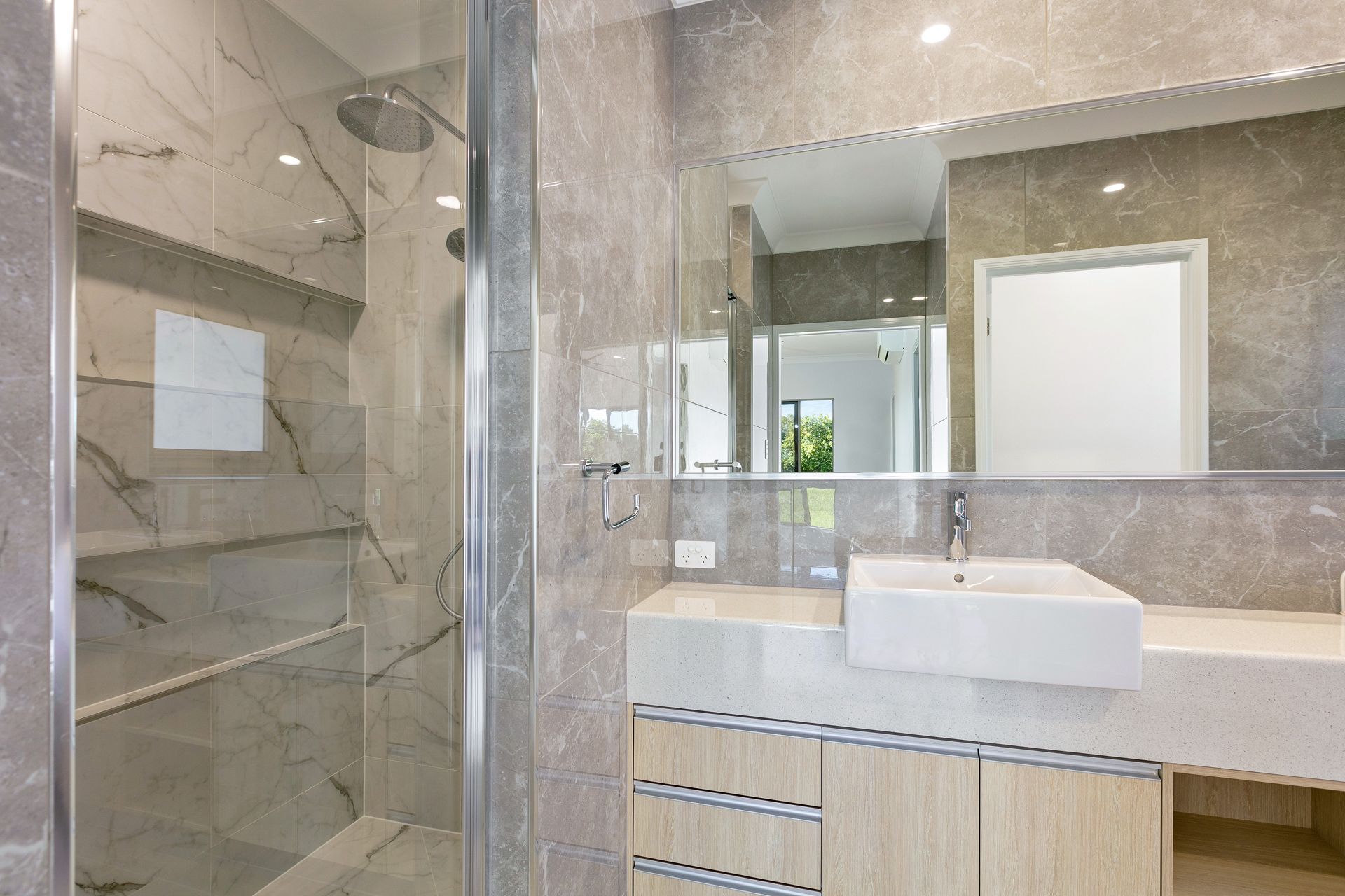 Modern Bathroom With Grey Marble-patterned Tile — Ashlee Jones Homes in Gordonvale, QLD