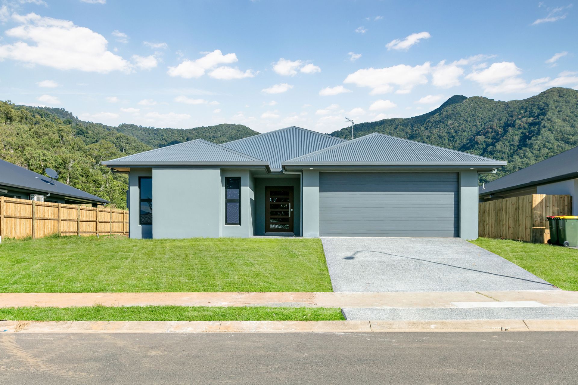 A Single-story, Light Grey Modern Suburban House With a Gray Tiled Roof — Ashlee Jones Homes in Gordonvale, QLD