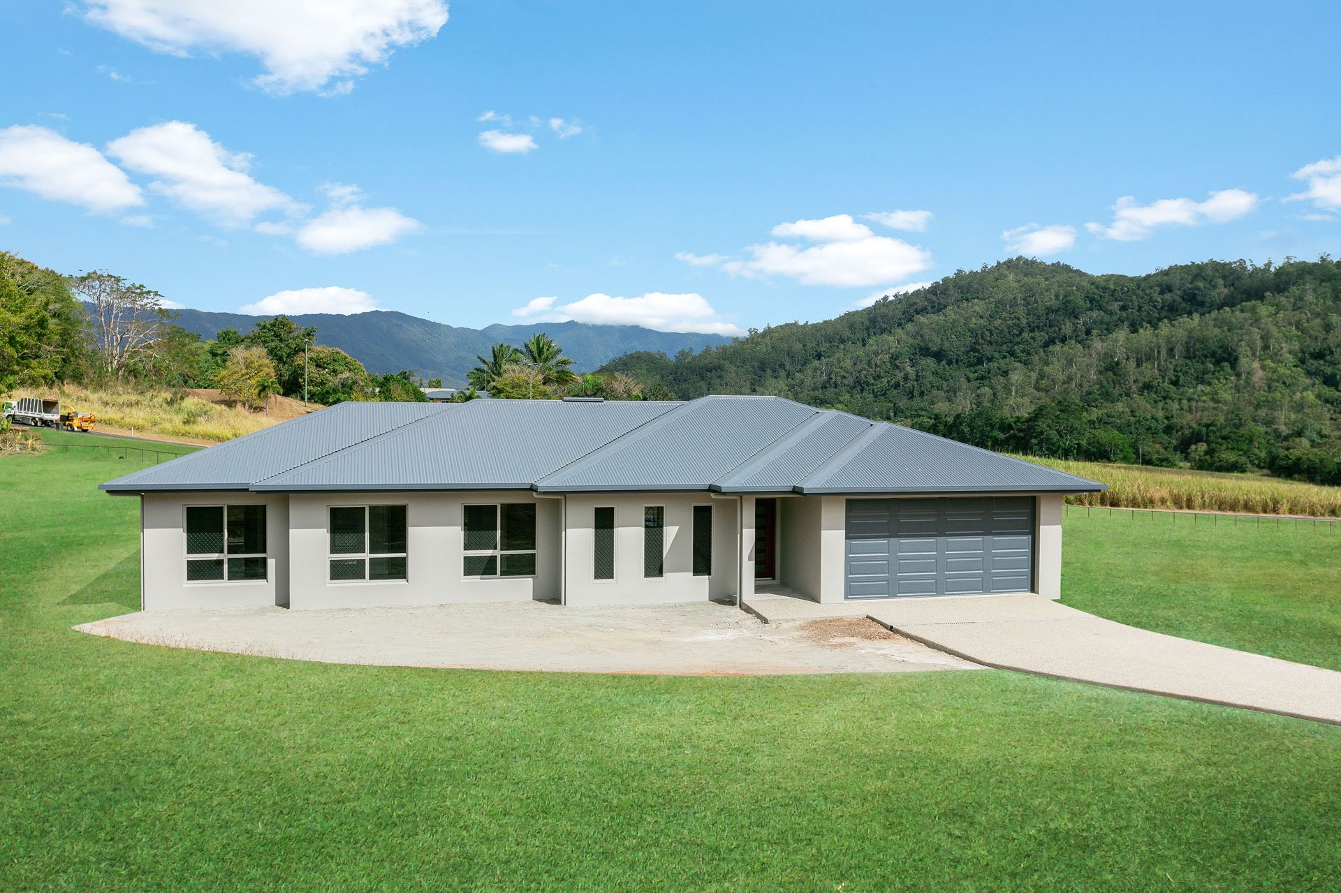 A Modern, Light-gray Single-story House With a Gray Roof and Garage — Ashlee Jones Homes in Gordonvale, QLD