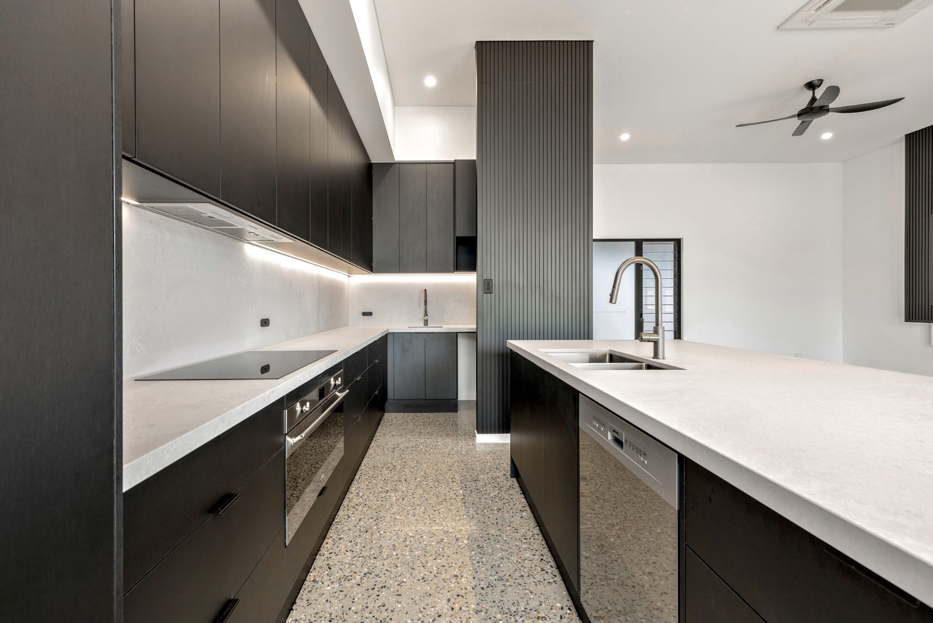 Modern Kitchen With Dark Cabinetry, White Countertops — Ashlee Jones Homes in Gordonvale, QLD