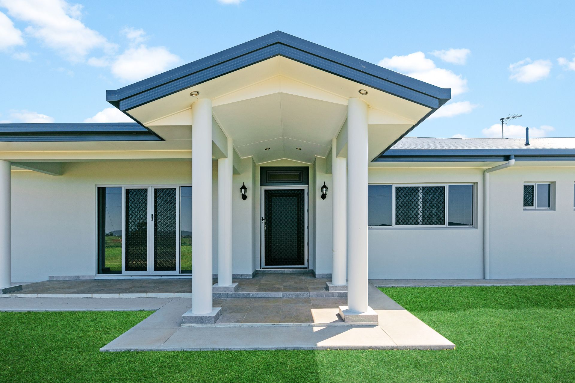 Modern White Single-story Home With a Central Covered Porch — Ashlee Jones Homes in Gordonvale, QLD