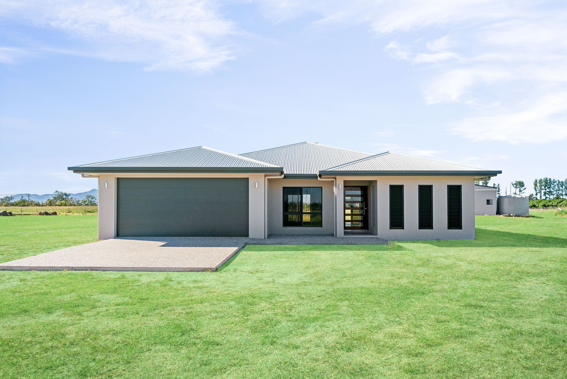 A Modern Single-story Beige House With a Grey Roof and Double Garage — Ashlee Jones Homes in Gordonvale, QLD