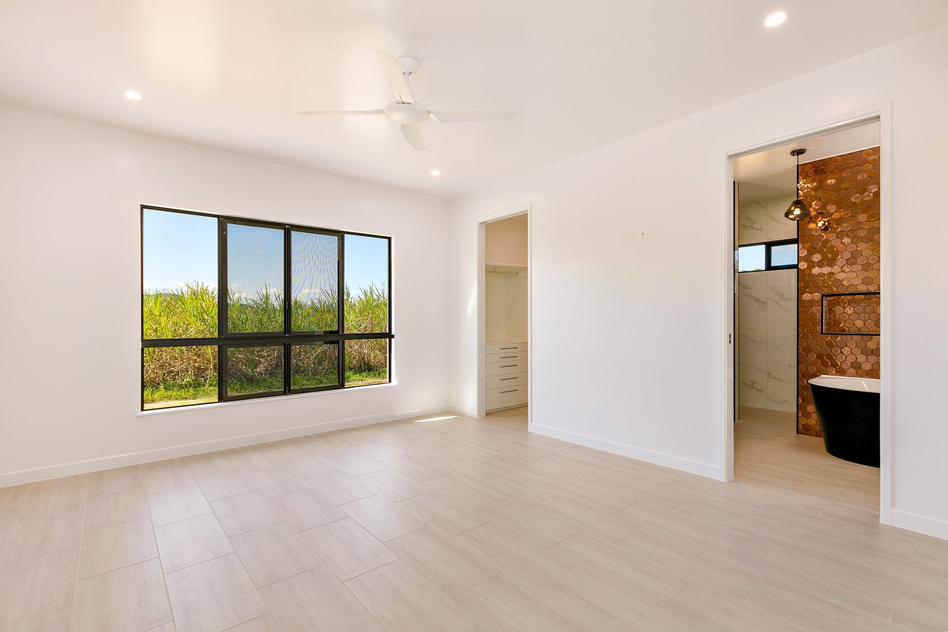 Modern Bedroom With White Walls, Light Wood Flooring — Ashlee Jones Homes in Gordonvale, QLD