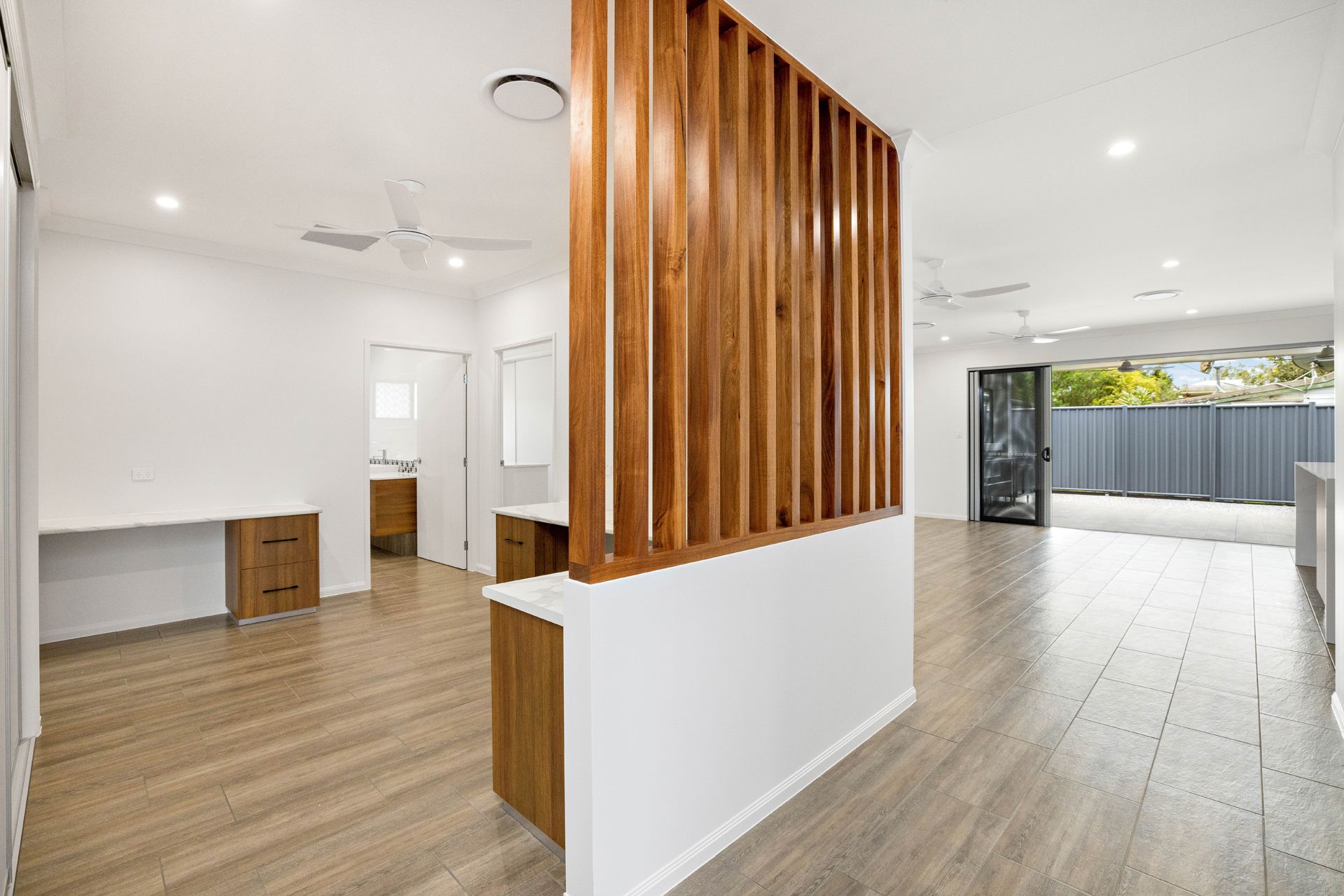 A Bright, Modern Room Featuring a Wooden Slat Room Divider — Ashlee Jones Homes in Gordonvale, QLD