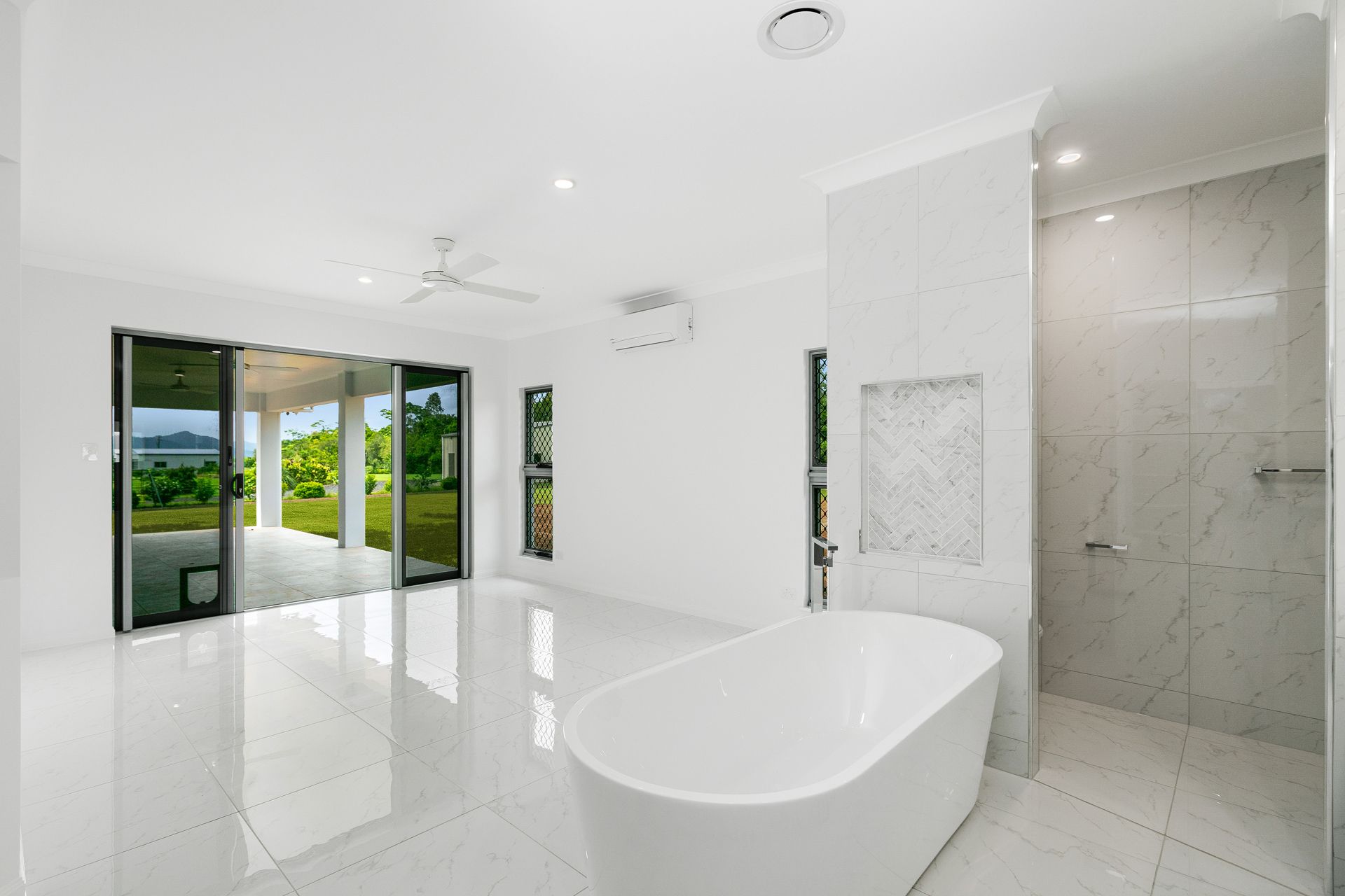 A Modern, Bright Bathroom With White Walls — Ashlee Jones Homes in Gordonvale, QLD