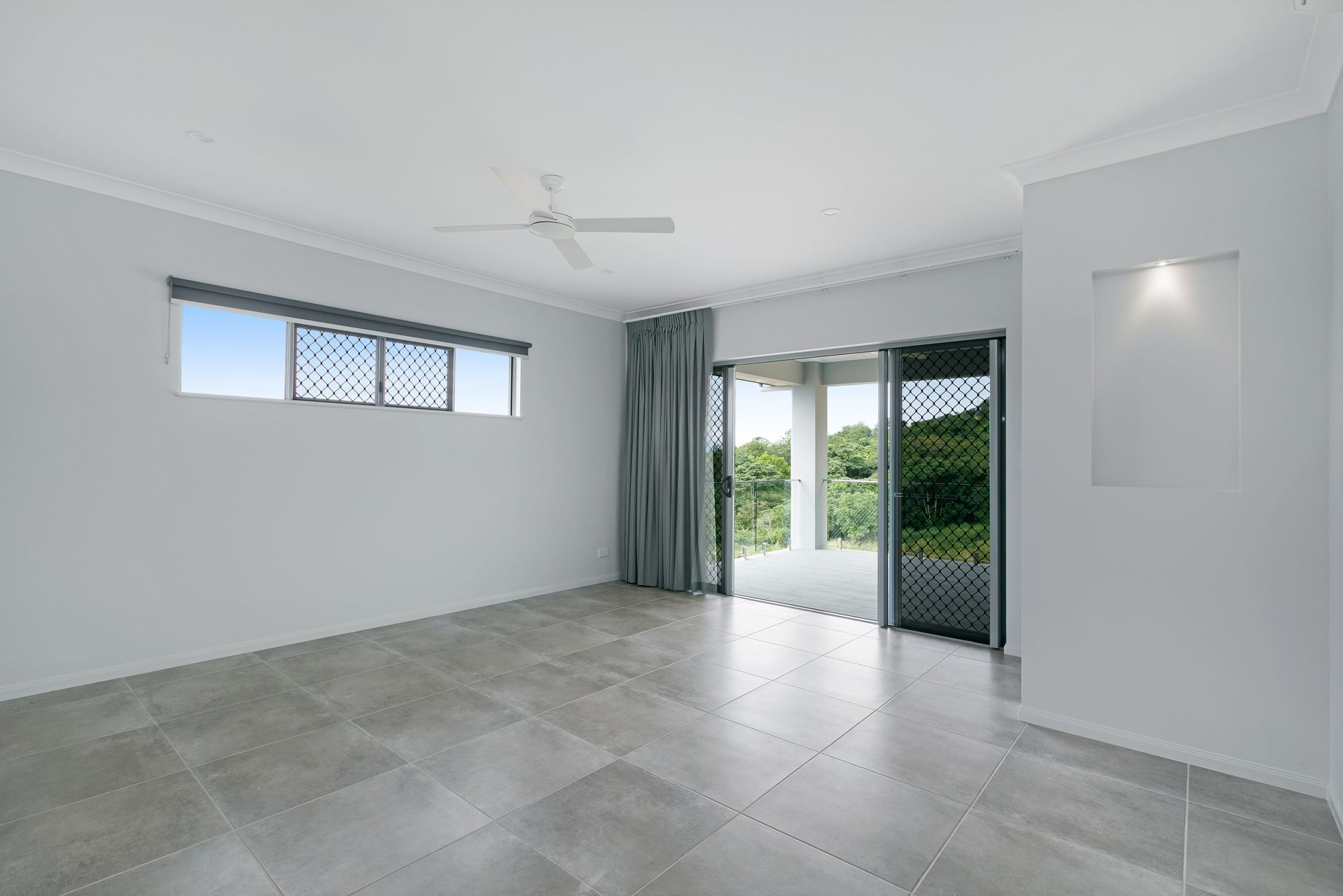 An Empty, Modern Room With Light Grey Walls — Ashlee Jones Homes in Gordonvale, QLD
