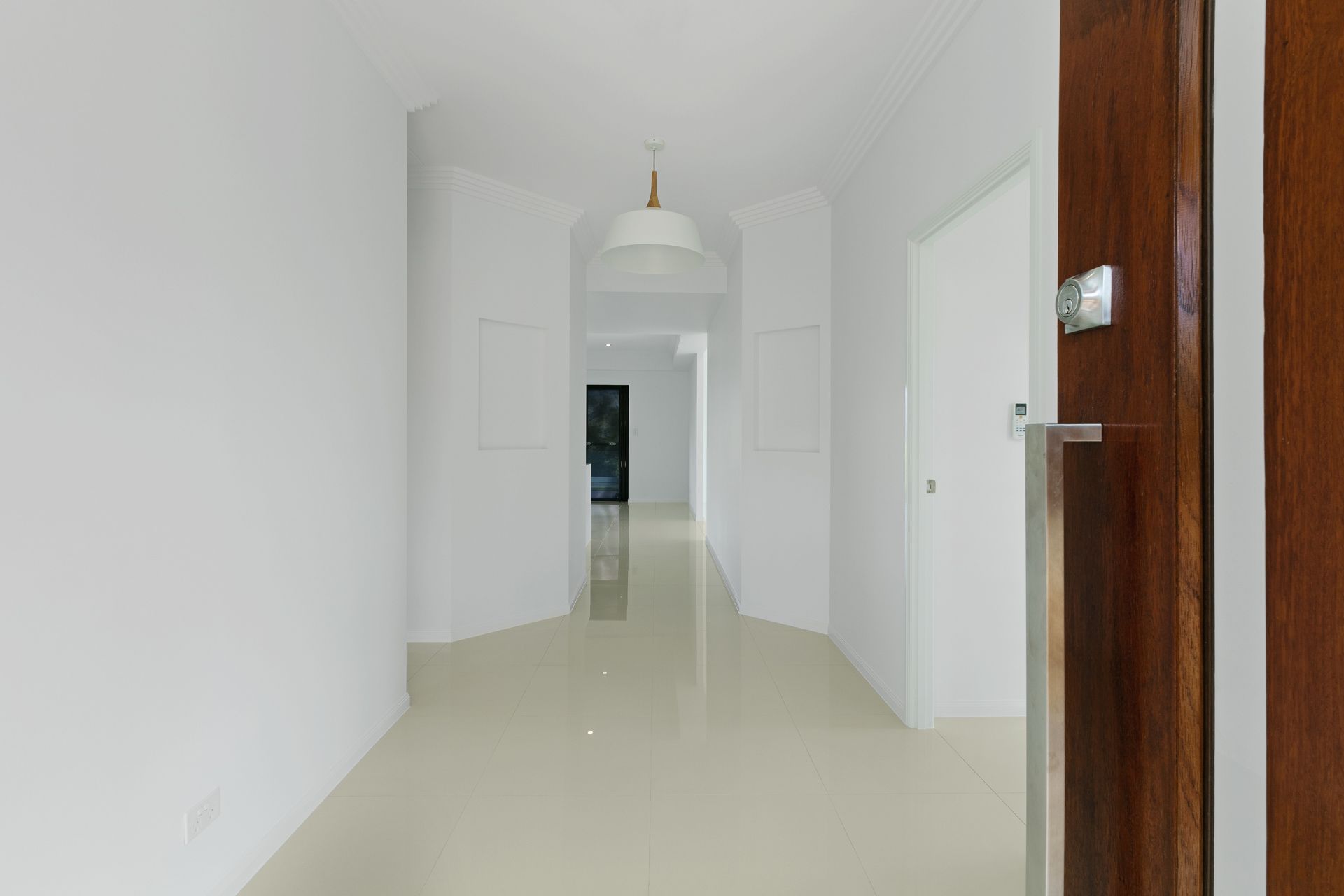 A Bright, Modern Entryway With White Walls — Ashlee Jones Homes in Gordonvale, QLD