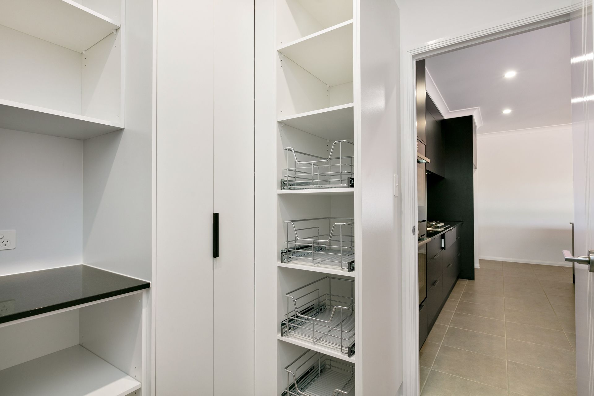 A Modern White Kitchen Pantry Featuring Open Shelves — Ashlee Jones Homes in Gordonvale, QLD