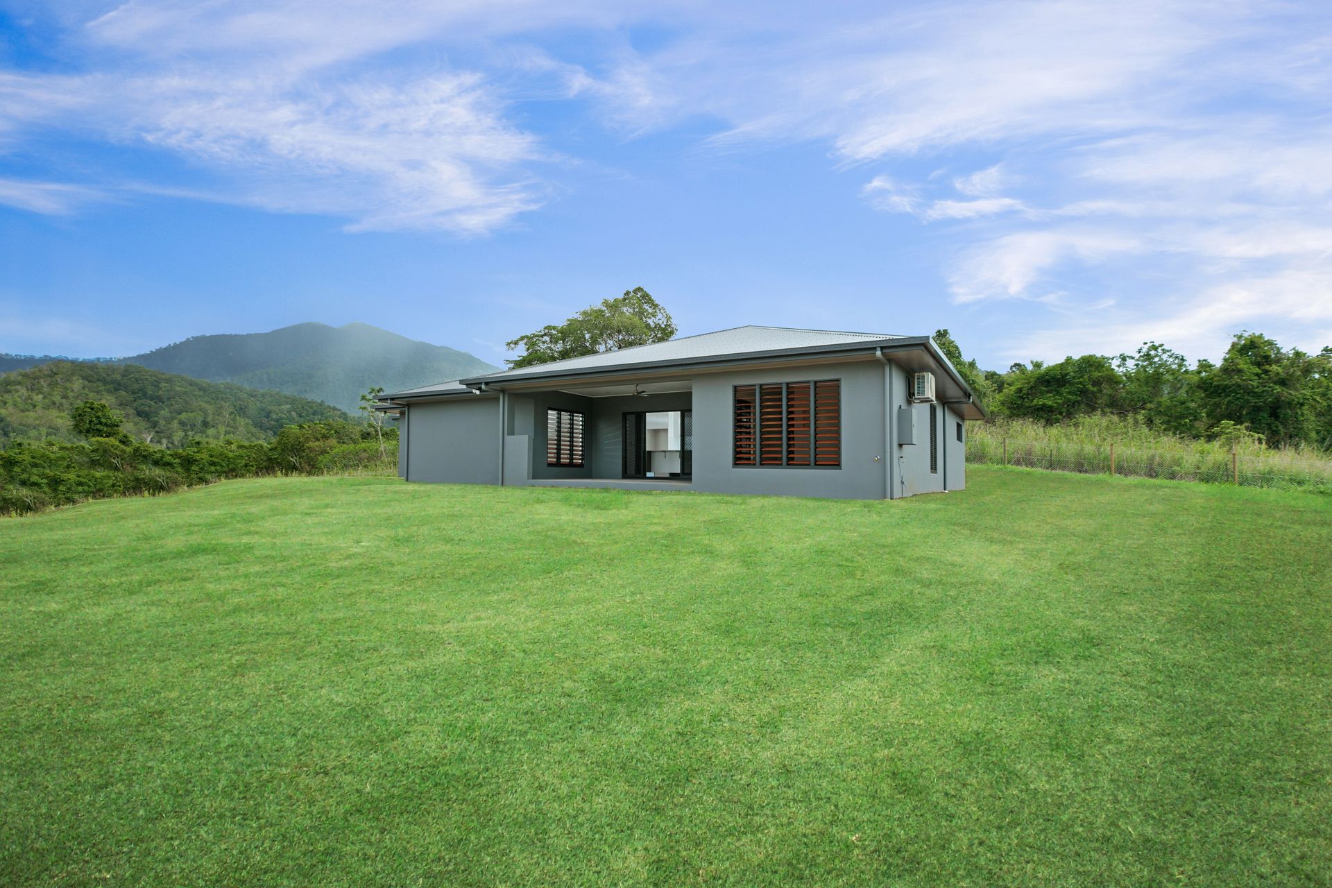 A Single-story Gray House Sits on a Vast, Green Lawn — Ashlee Jones Homes in Gordonvale, QLD