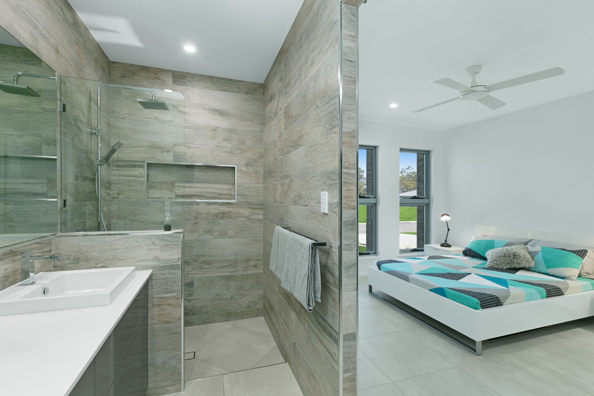 Modern Bedroom Featuring a Walk-in Shower With Grey Stone Tiles — Ashlee Jones Homes in Gordonvale, QLD
