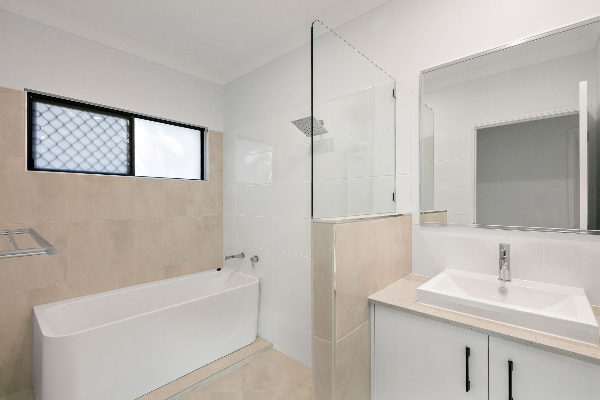 Modern Bathroom With a White Bathtub, a Glass-enclosed Shower — Ashlee Jones Homes in Gordonvale, QLD