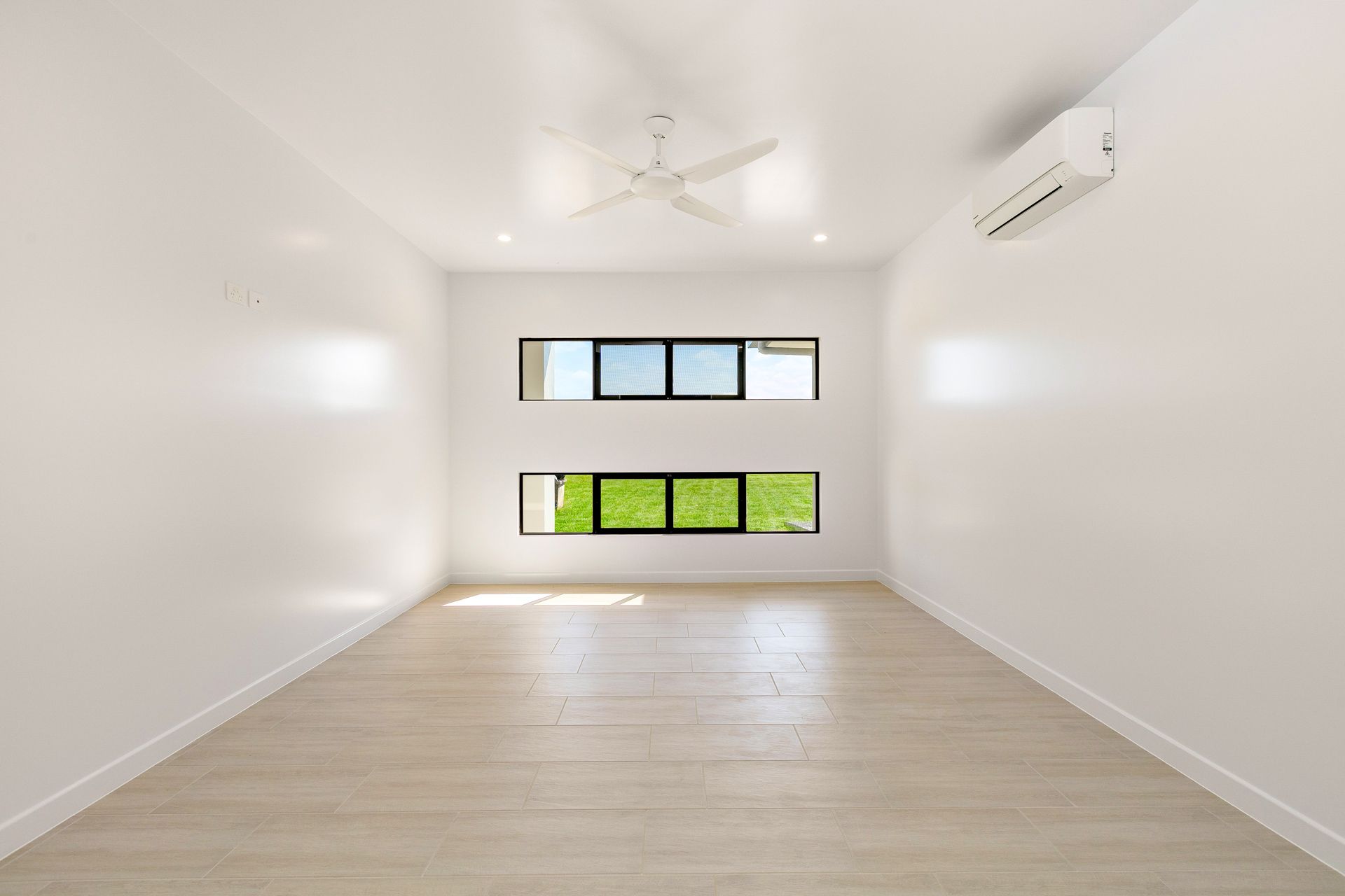 A Minimalist, Empty Room With Plain White Walls — Ashlee Jones Homes in Gordonvale, QLD