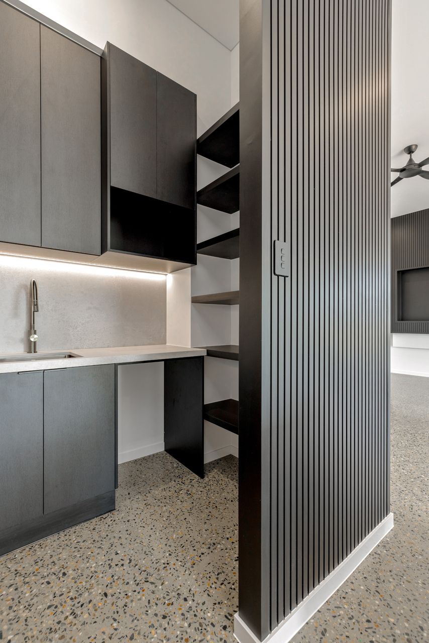 Modern Kitchen Area With Matte Black Cabinets — Ashlee Jones Homes in Gordonvale, QLD