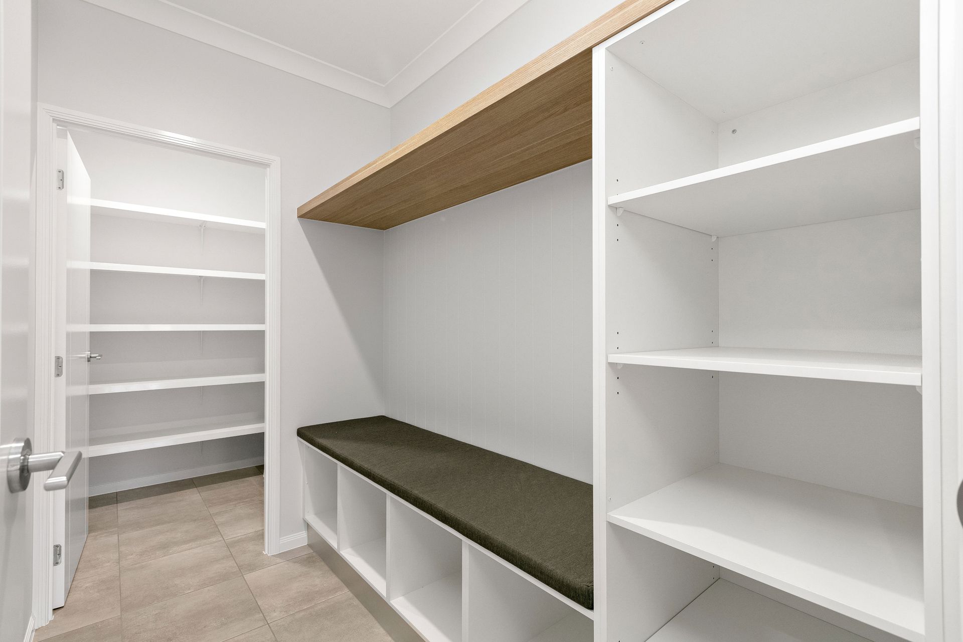 A Modern Mudroom Featuring White Built-in Storage Cabinets — Ashlee Jones Homes in Gordonvale, QLD