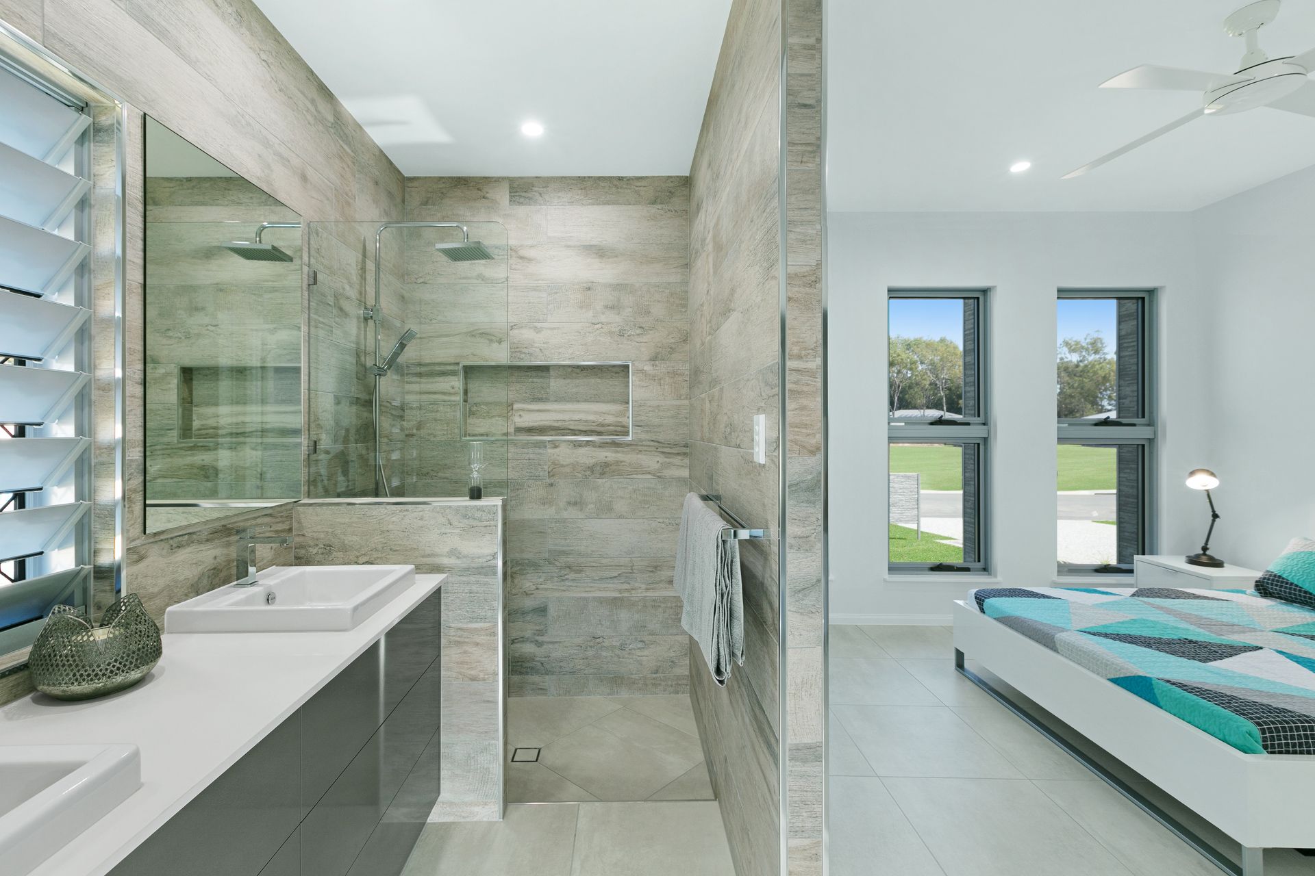 A Modern suite Bathroom With a Stone-tiled Walk-in Shower — Ashlee Jones Homes in Gordonvale, QLD